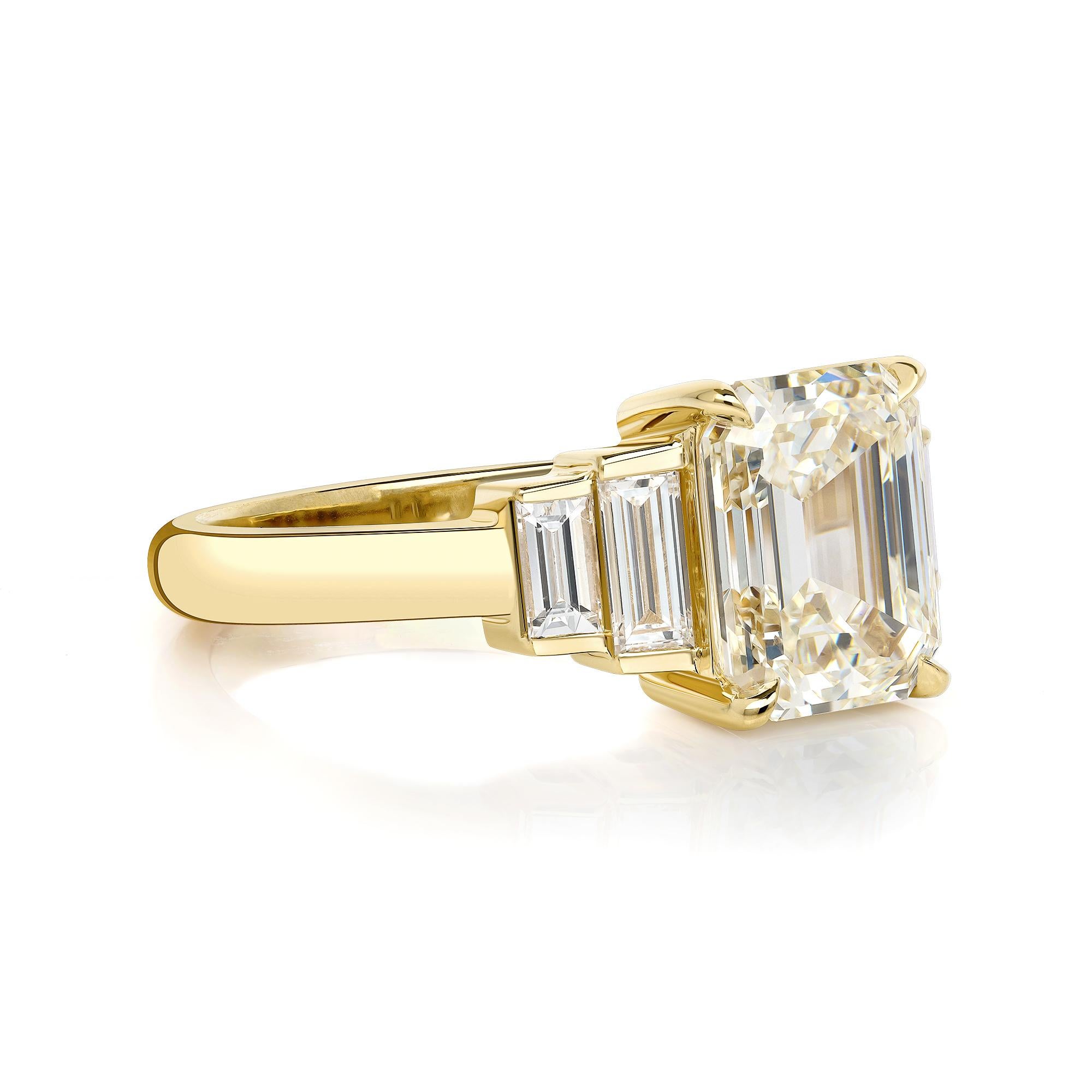 2.31ct K/VS1 GIA certified emerald cut diamond with 0.44ctw baguette cut accent diamonds prong set in a handcrafted 18K yellow gold mounting. 

 