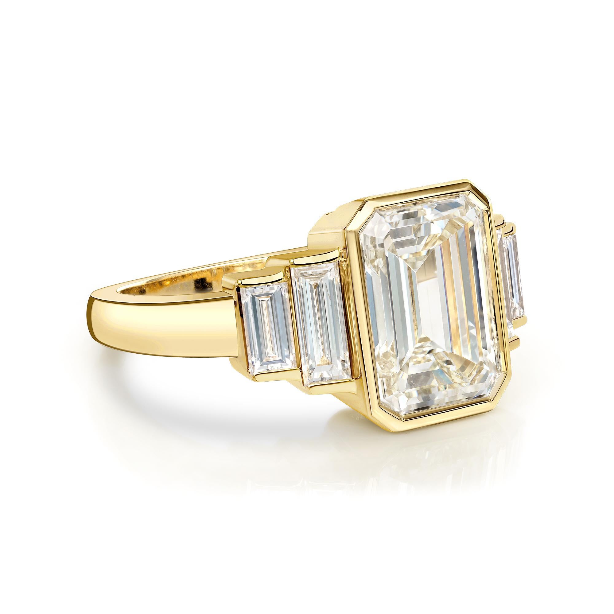 3.09ct N/VS1 GIA certified Emerald cut diamond with 0.74ctw baguette cut accent diamonds bezel set in a handcrafted 18K yellow gold mounting.