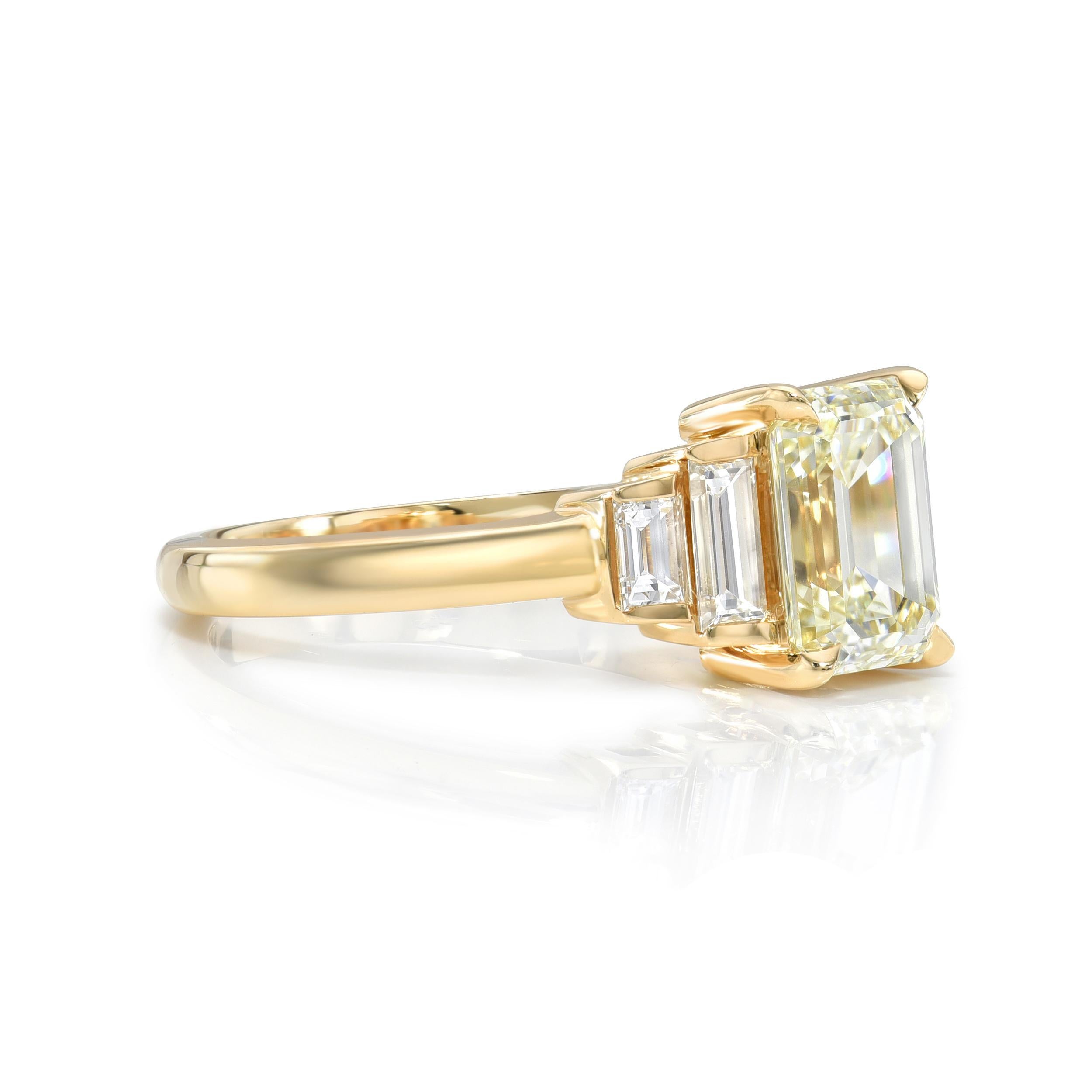 1.50ct M/VVS1 GIA certified emerald cut diamond with 0.39ctw baguette cut accent diamonds prong set in a handcrafted 18K yellow gold mounting.