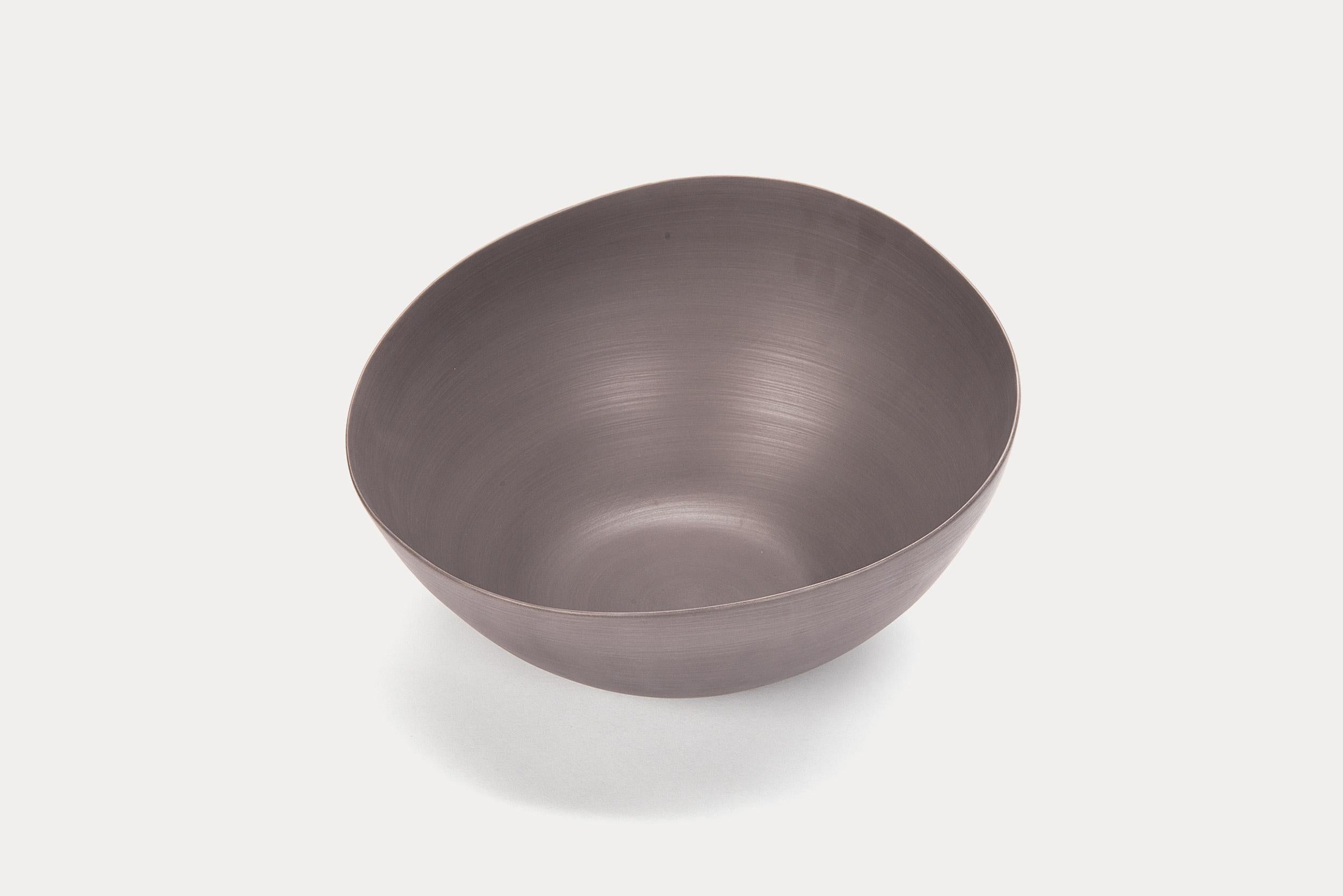 This bowl exhibits the simple, handcrafted lines of Rina Menardi ceramnics. The dark indigo hue would mix beautifully in any home.