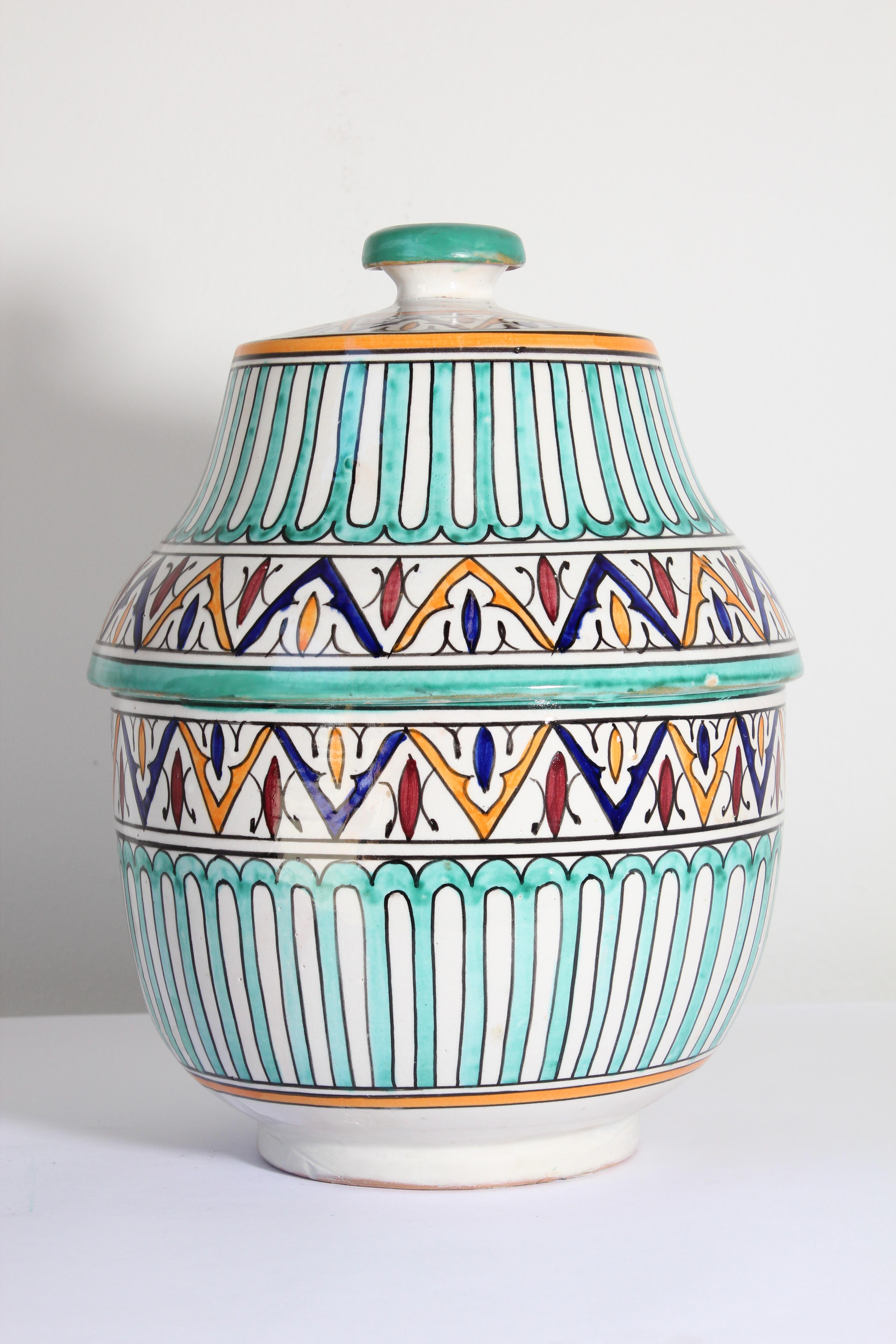 Moroccan glazed polychrome ceramic jar tureen with cover.
Hand painted ceramic Jubbana, handcrafted by skilled Moroccan artisans in Fez Morocco.
Moorish designs in turquoise, cobalt blue, teal, saffron yellow, prune and ivory colors.
Size: 14