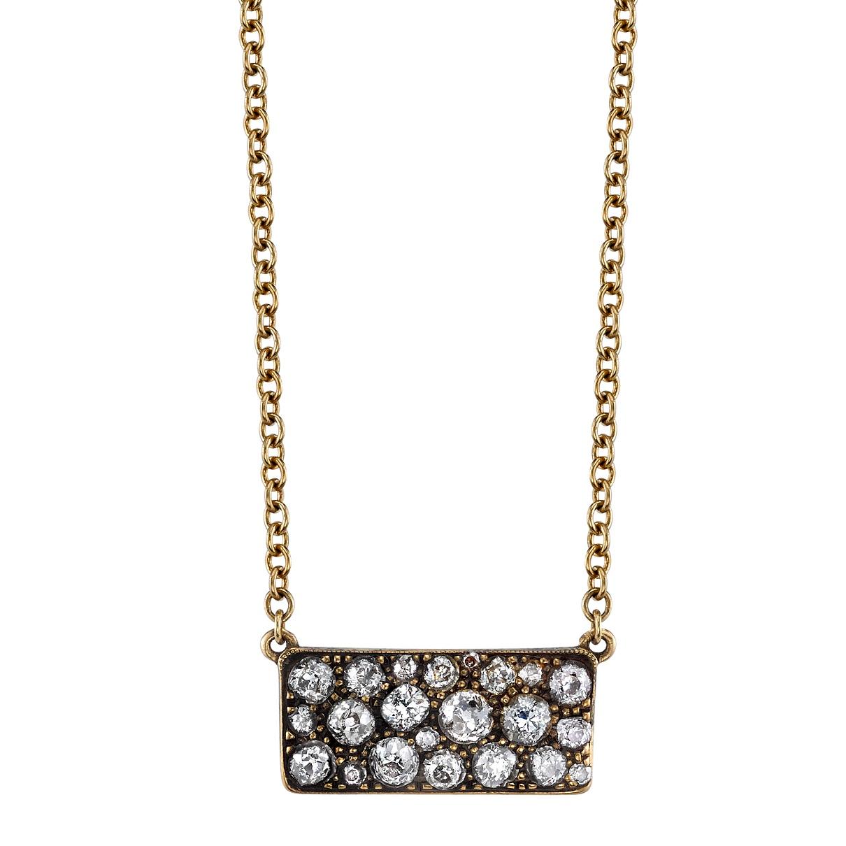 Approximately 1.05ctw varying old cut and round brilliant cut diamonds in a handcrafted oxidized or polished 18k yellow gold pendant.  Price may vary according to total diamond weight.  Necklace includes 18