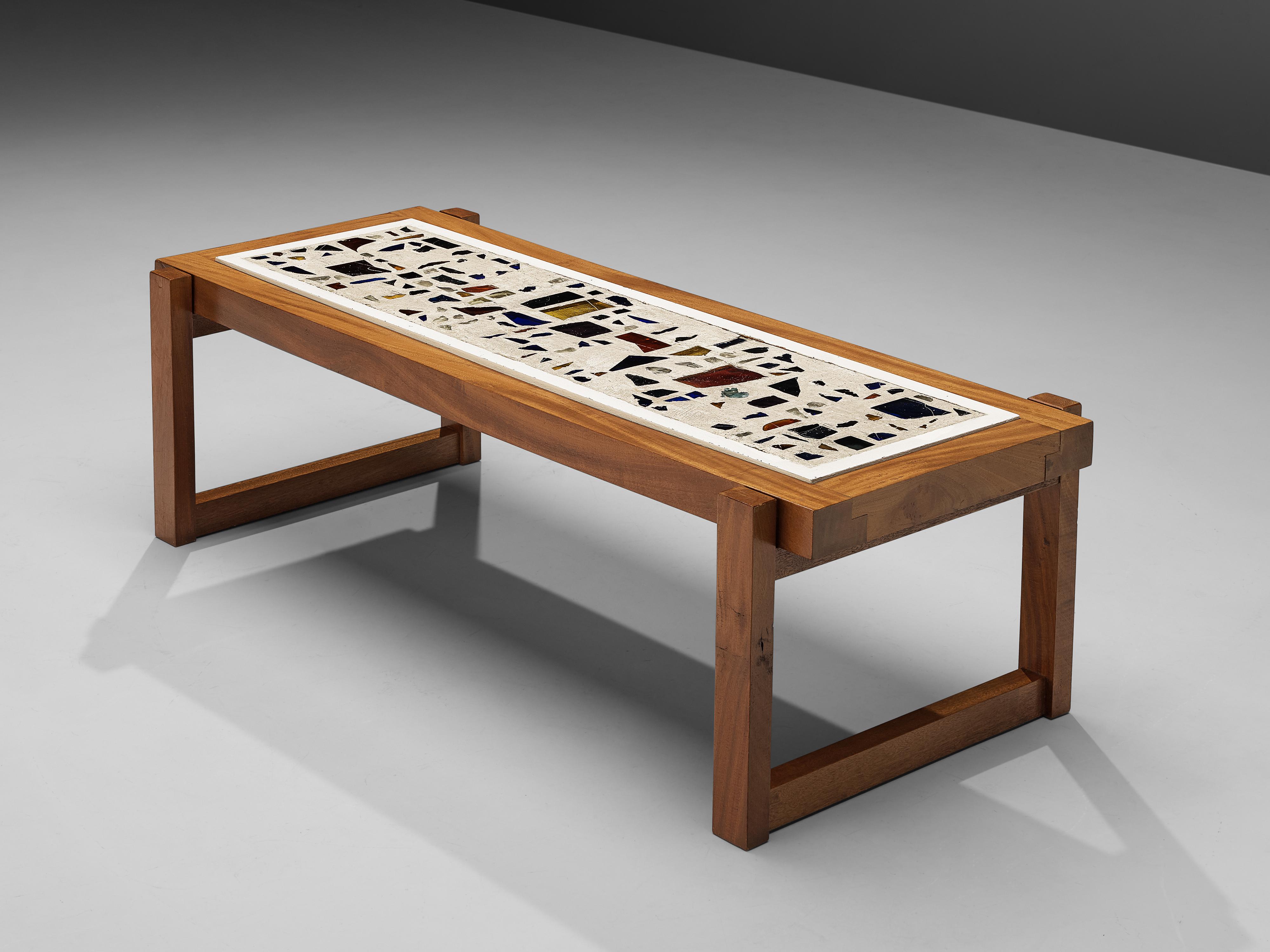 Rectangular coffee table, teak, concrete, glass, brass, Germany, 1980s

The inlay with multicolored glass fragments surrounded by concrete gives this table an artistic look. Each glass element shows an individual look and together they form a