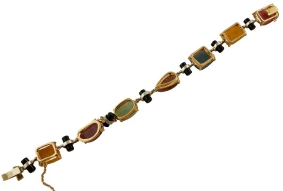 Mixed Cut Handcrafted Colored Sapphires, Diamonds, Onyx, Yellow and White Gold Bracelet For Sale