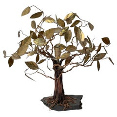 Lámpara de mesa artesanal de cobre y latón con forma de árbol sobre una base de pizarra, de diseño moderno y orgánico