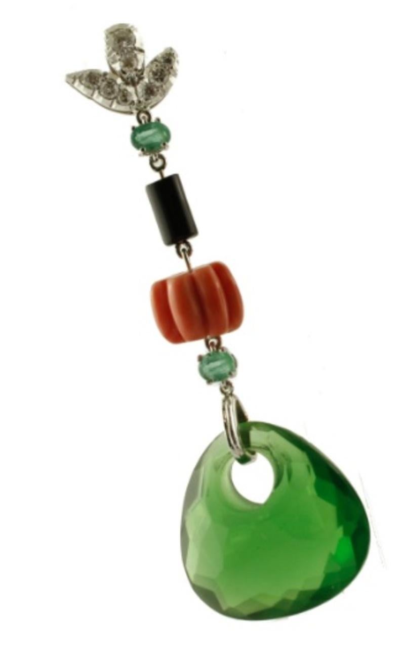 Dangle earrings in 14k white gold structure, mounted with a flowery upper part studded with diamonds, and dangle decoration of emeralds, onyx, elatius coral and green hard stones.
These earrings are totally handmade by Italian master