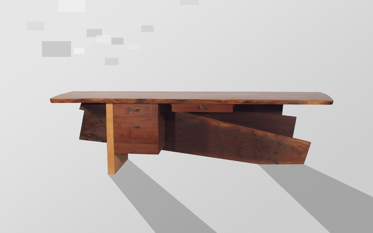 A wonderful, hand-made, walnut Desk by Stuart Welch. Solid and striking design, contemporary/modern with a rustic flair. This desk makes a statement anywhere home or office. 

About the artist: 
People often ask where do I get my ideas? Early on