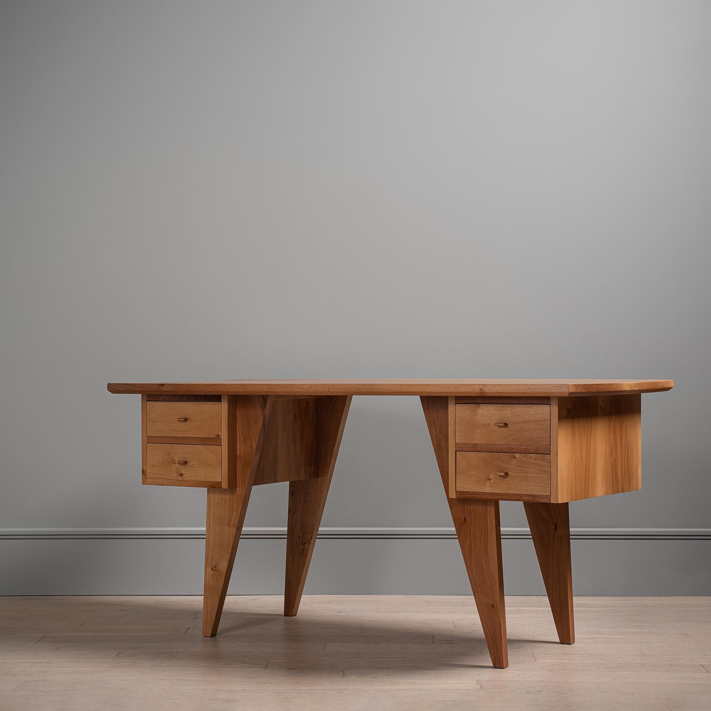 A unique and totally handcrafted desk. Designed and handmade in England by master craftsmen using traditional woodworking and cabinetry techniques. Hidden jointing and exposed acute dovetailing. The beautiful desk surface is created using wide solid