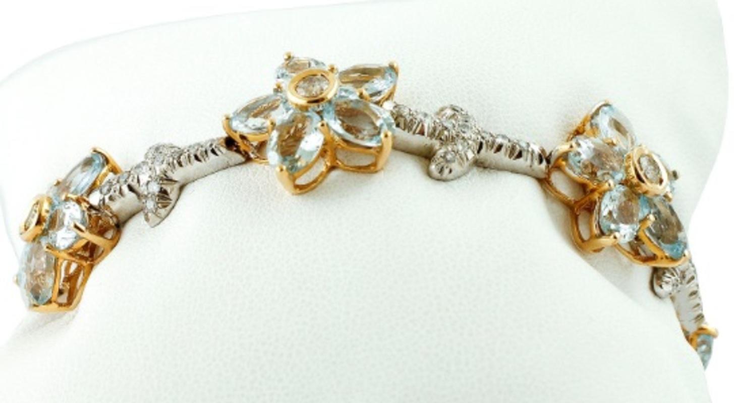 Link bracelet realized in 14k white and yellow structure, mounded with modular sections of aquamarine flowers, linked by white gold structure studded with diamonds.
The origin of this bracelet dates probably back to the 1990s, it was totally