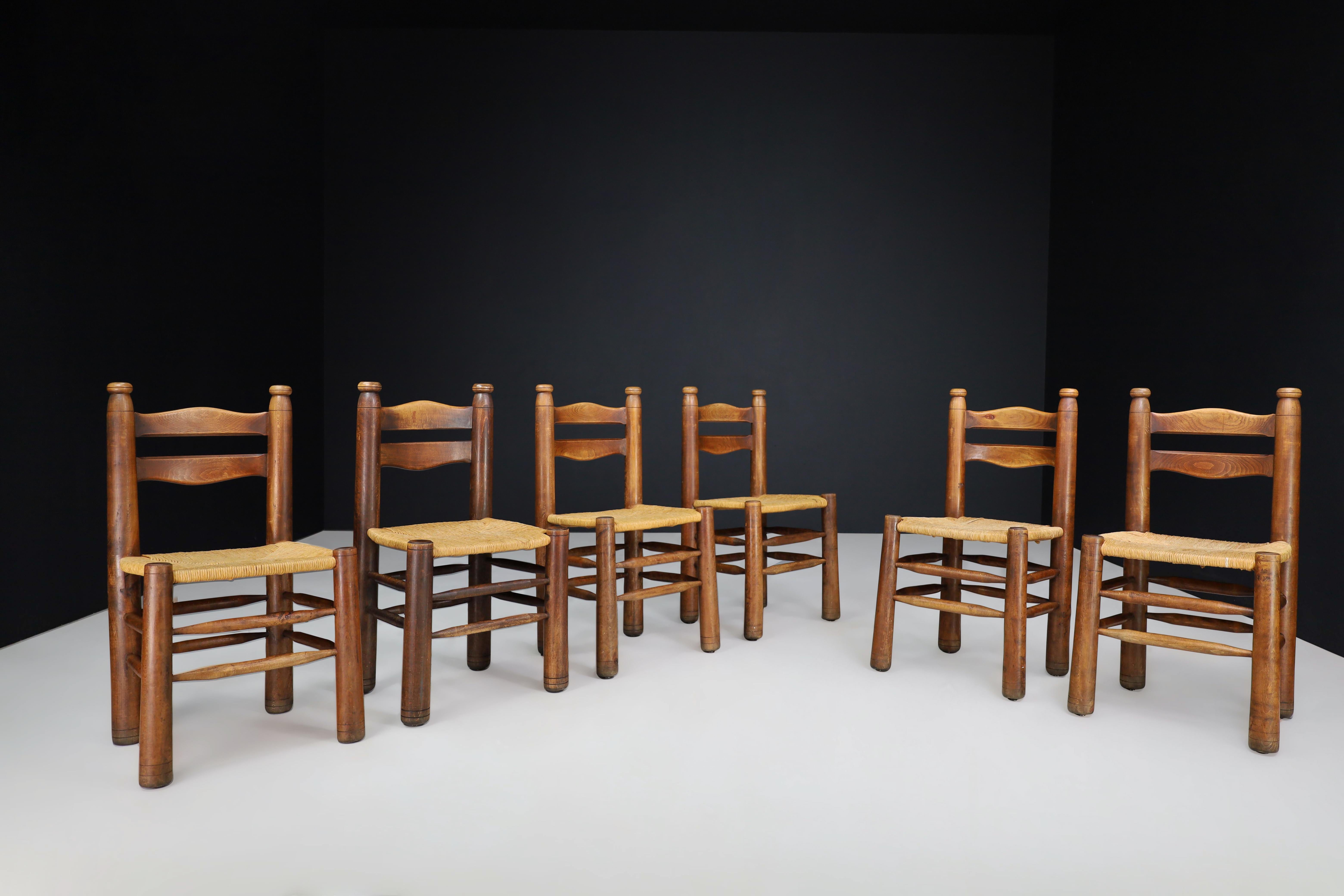 Handcrafted Dining room chairs in wood and rush, France 1940s

These handcrafted dining room chairs are crafted from rustic wood and rush in the style of Charles Dudouyt, dating back to 1940s France. The set includes eight chairs in excellent