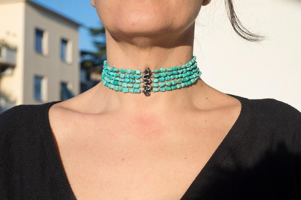 Questo squisito girocollo disegnato da Rossella Ugolini presenta uno splendido drago centrale realizzato a mano in argento brunito, tempestato di scintillanti diamanti grigi. Il drago aggiunge un tocco di ispirazione mitica al pezzo, rendendolo un