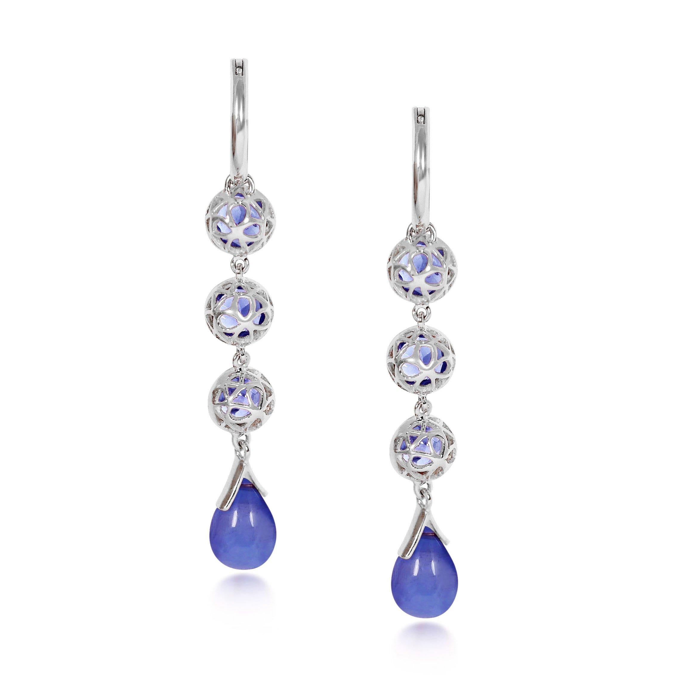 Handcrafted 1.65 Carats Tanzanites 18 Karat White Gold Drop Earrings. Our stone cascade-like earrings are an elegant statement underlined by romantic dancing drops carved in Tanzanite under a set of 6mm round cut Tanzanite stones encased in our