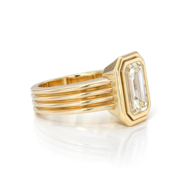 3.03ct N/VS2 GIA certified emerald cut diamond bezel set in a handcrafted 18K yellow gold mounting.