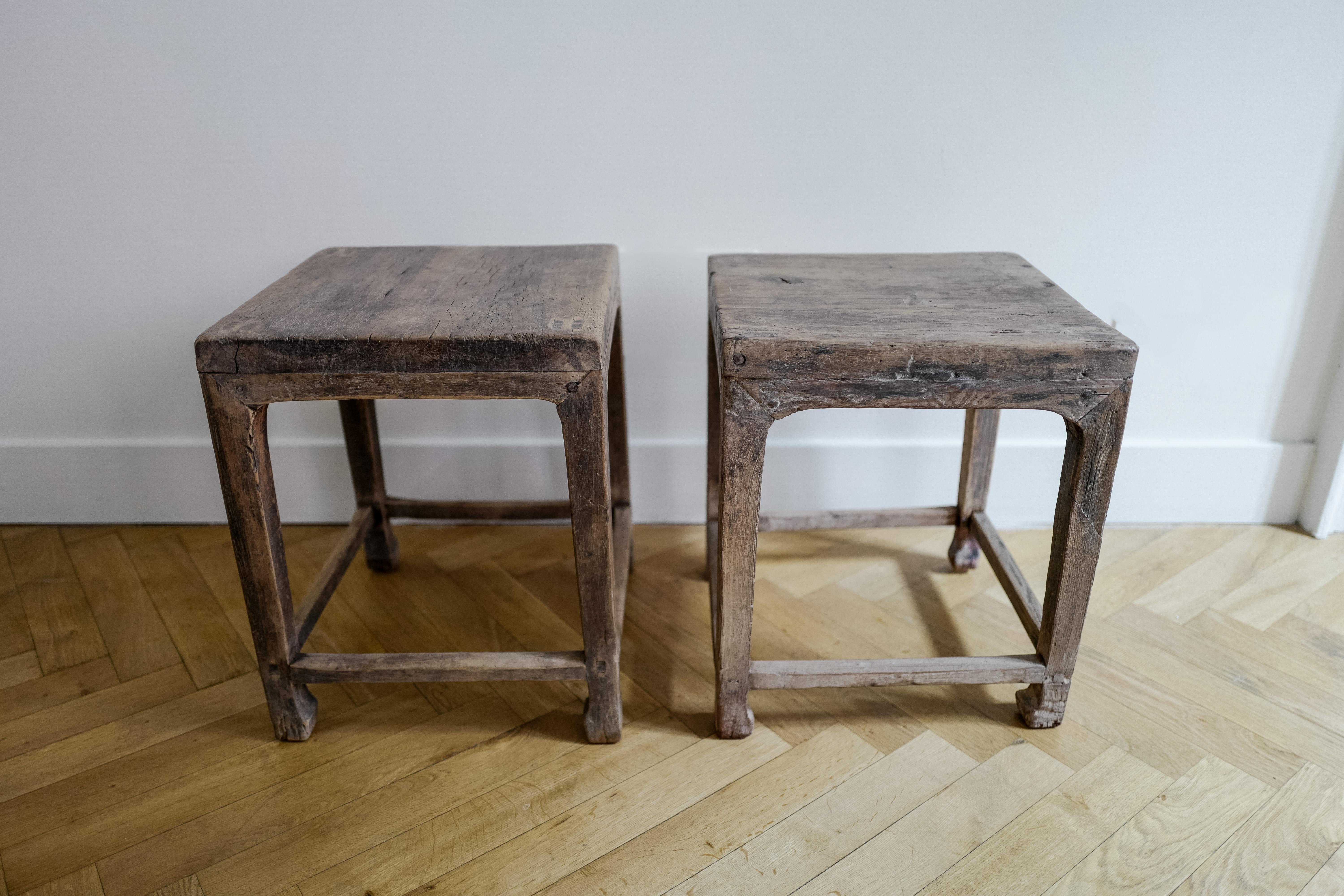A pair of handcrafted square elm wood side tables or stools made in China, circa early 20th century.