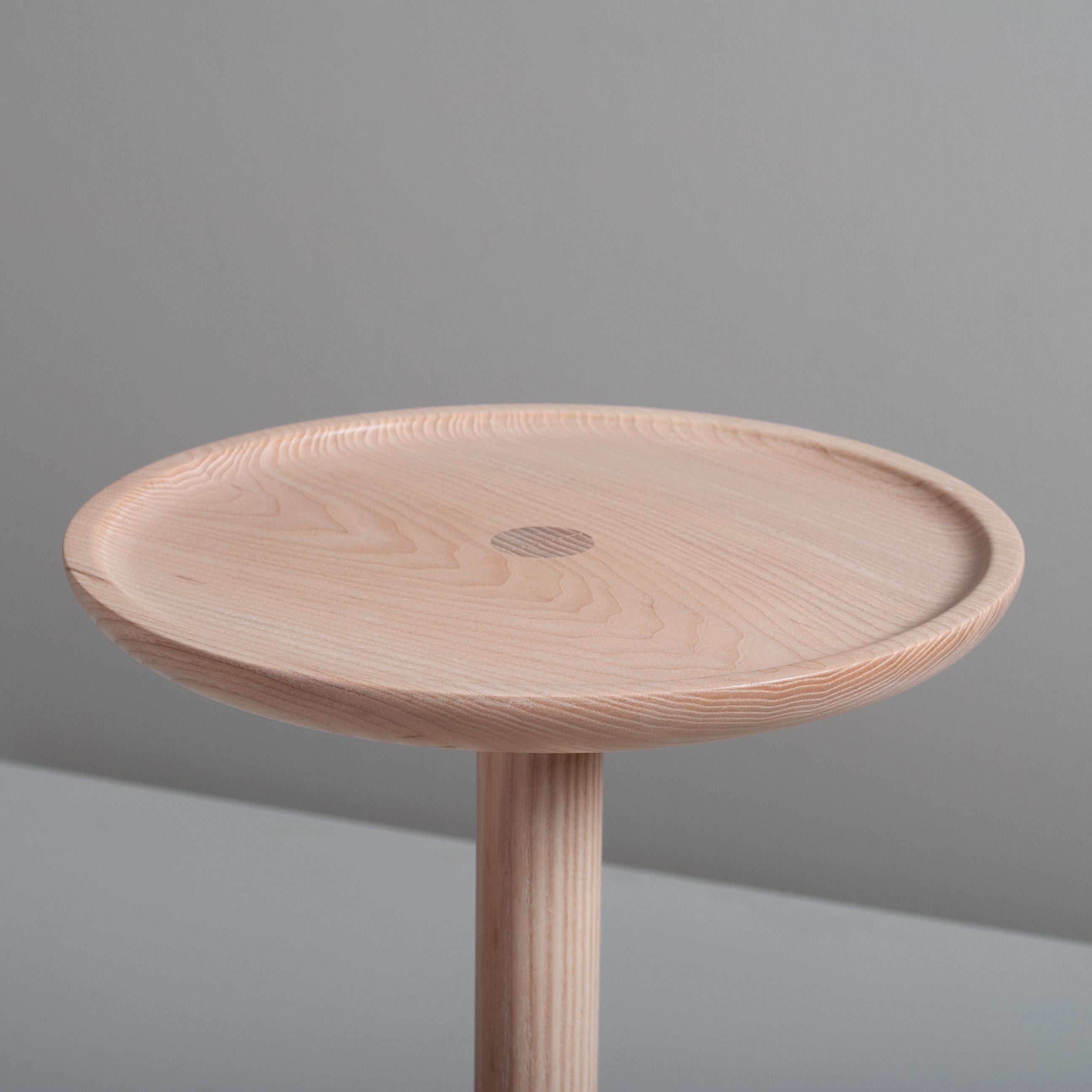 Beautifully hand turned and handcrafted English ash side table in the modernist design. A wonderful piece of craftsmanship. The top surface has a concave 'dished' rim design with visible centre joint detail. This is a bespoke piece of fine quality,