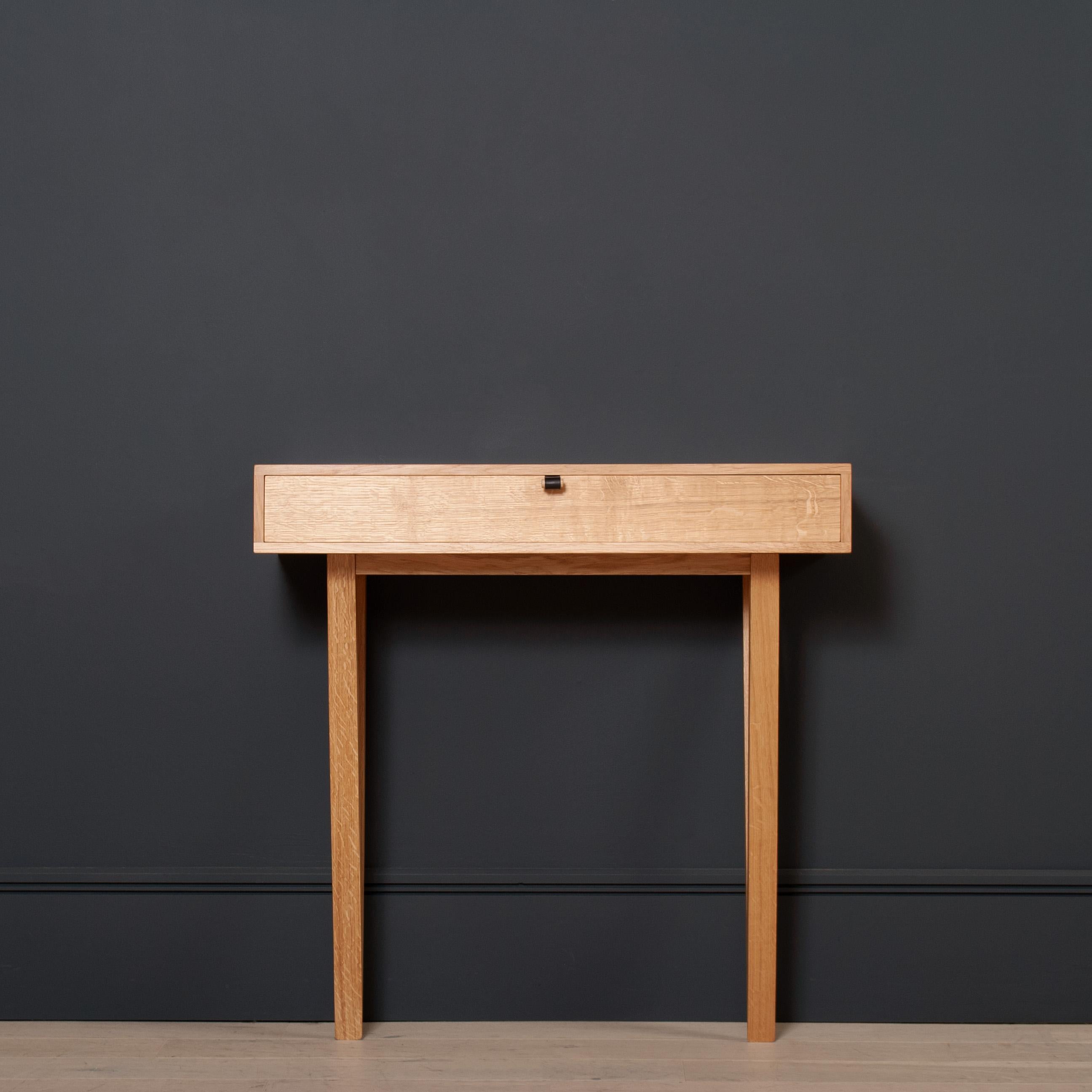 Modernist console table designed and handmade in England using traditional furniture making techniques. Completely handcrafted from fully quarter-sawn English oak. Hand dovetailed joints to the main oak box and inner drawer parts. Can also be used
