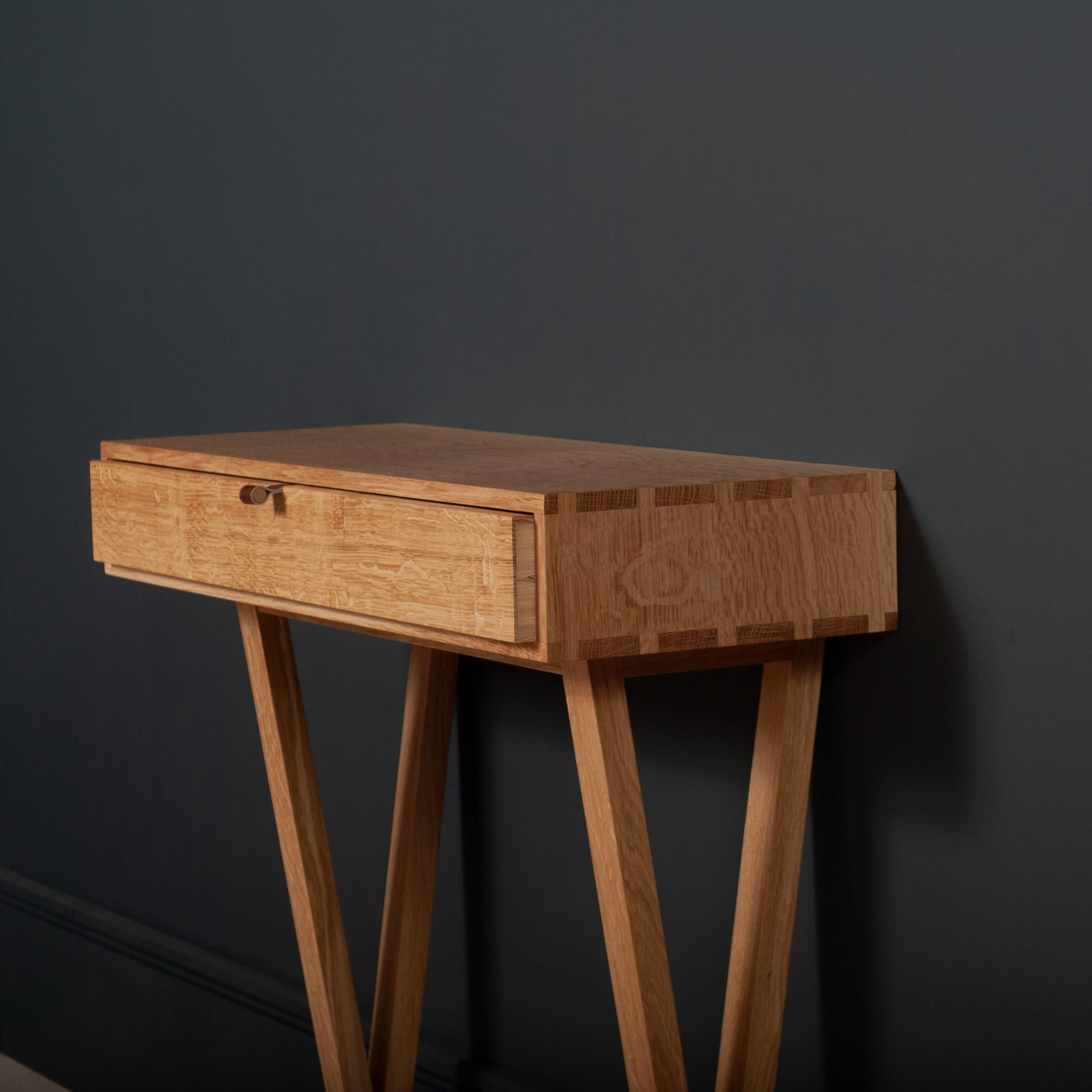 Modernist console table designed and handmade in England using traditional furniture making techniques. Completely handcrafted from fully quarter-sawn English oak. Hand dovetailed joints to the main oak box and inner drawer parts. Can also be used