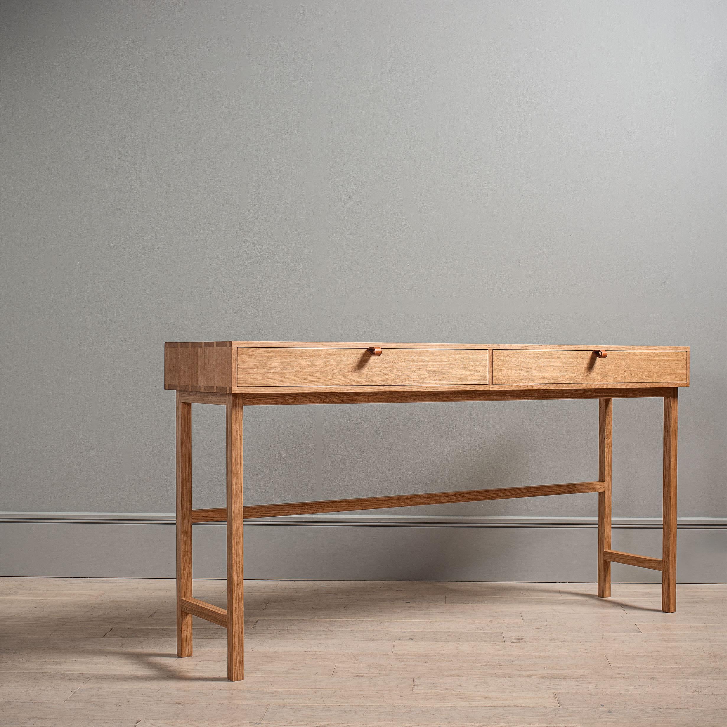 A new freestanding modern English oak desk design. Designed and handmade in England using skilled traditional furniture making techniques. Completely handcrafted from the finest fully quarter-sawn English oak. Hand dovetailed joints surround the oak
