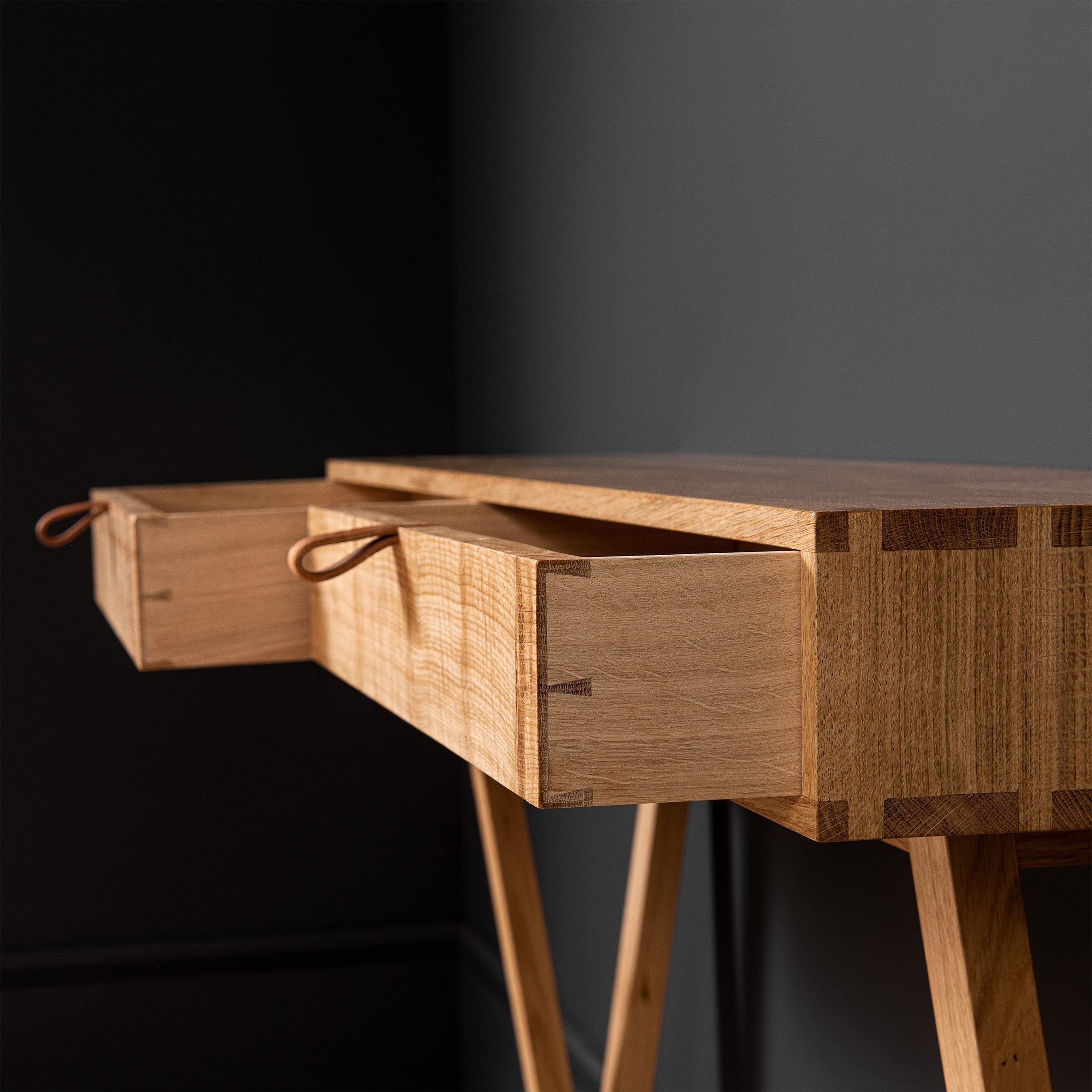 Modernist oak entry console table with drawers designed and produced in England using traditional furniture making techniques. Completely handcrafted from the finest fully quarter-sawn English oak. Hand dovetailed joints to the main oak box and all