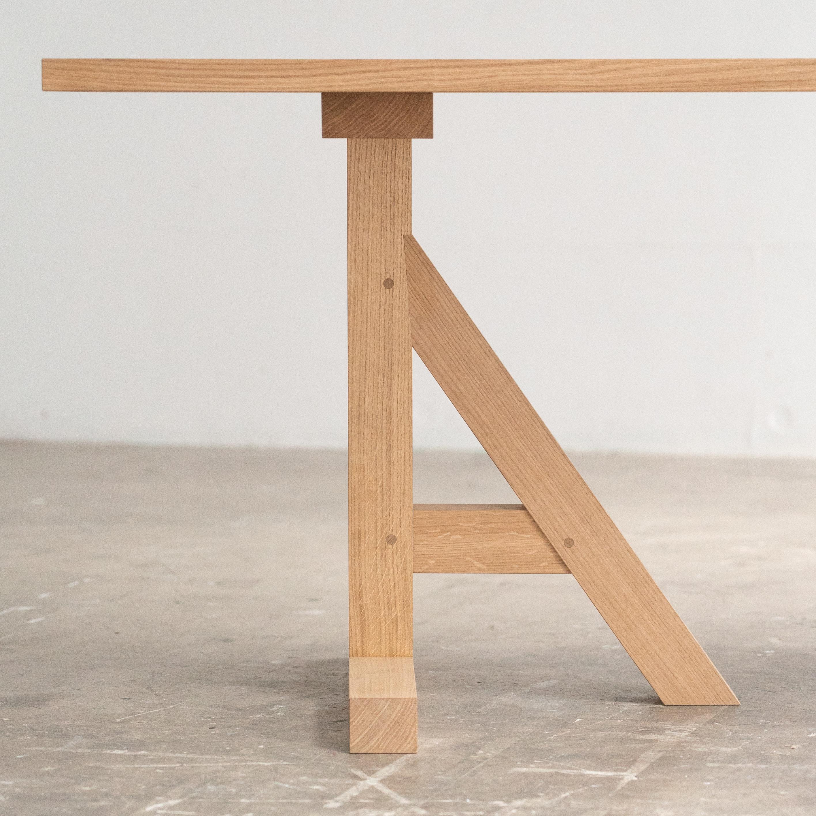 Handcrafted English prime white oak table. This substantial table is totally crafted from scratch using hand tools with finely skilled traditional British furniture making techniques and joints. A contemporary take on a centuries old idea. 
Finished