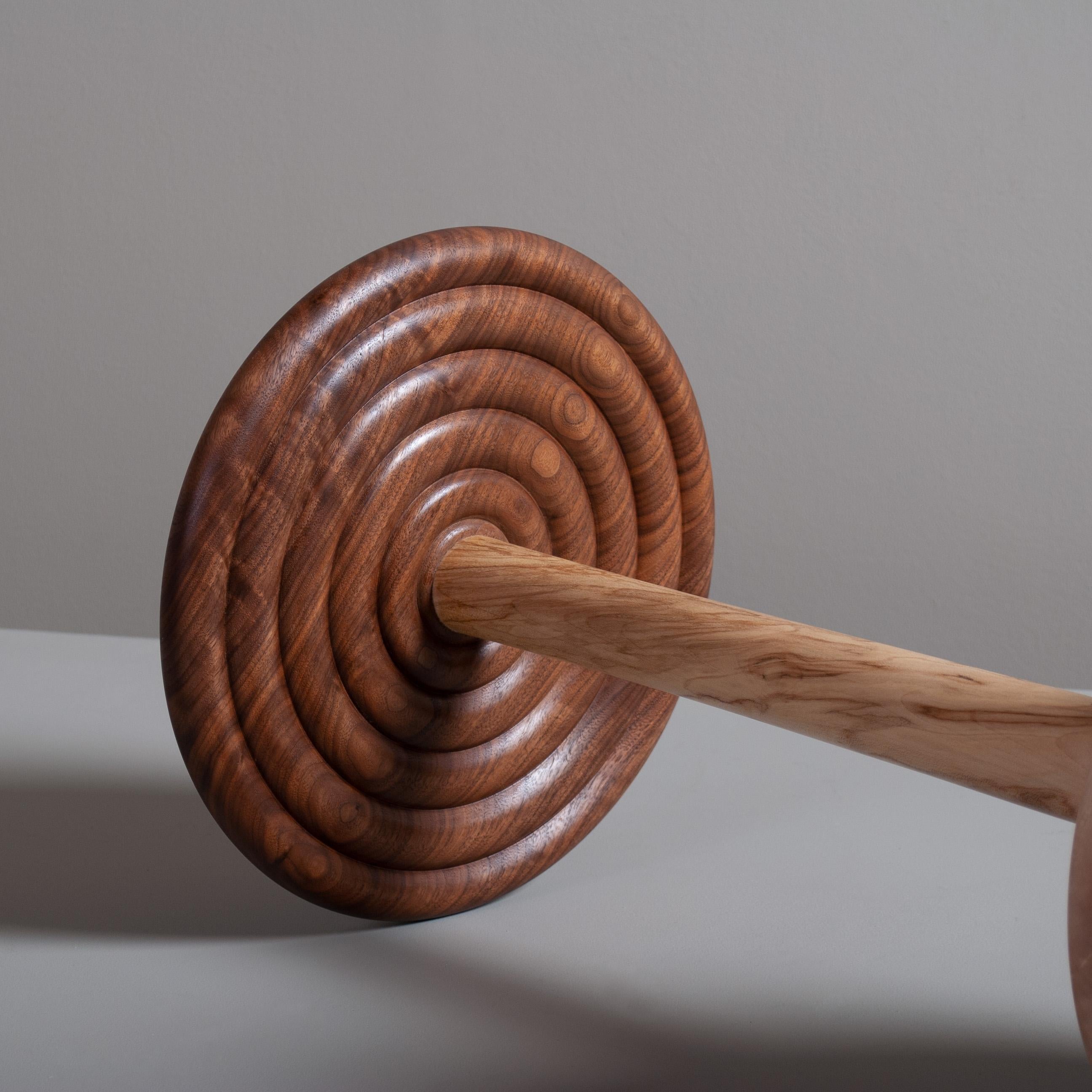 Beautifully hand turned and handcrafted English sycamore/maple and walnut side table in the modernist design. The top surface has a pillowed ripple turned underside and the base a superb rounded rim taper ascending to join the centre column. This is