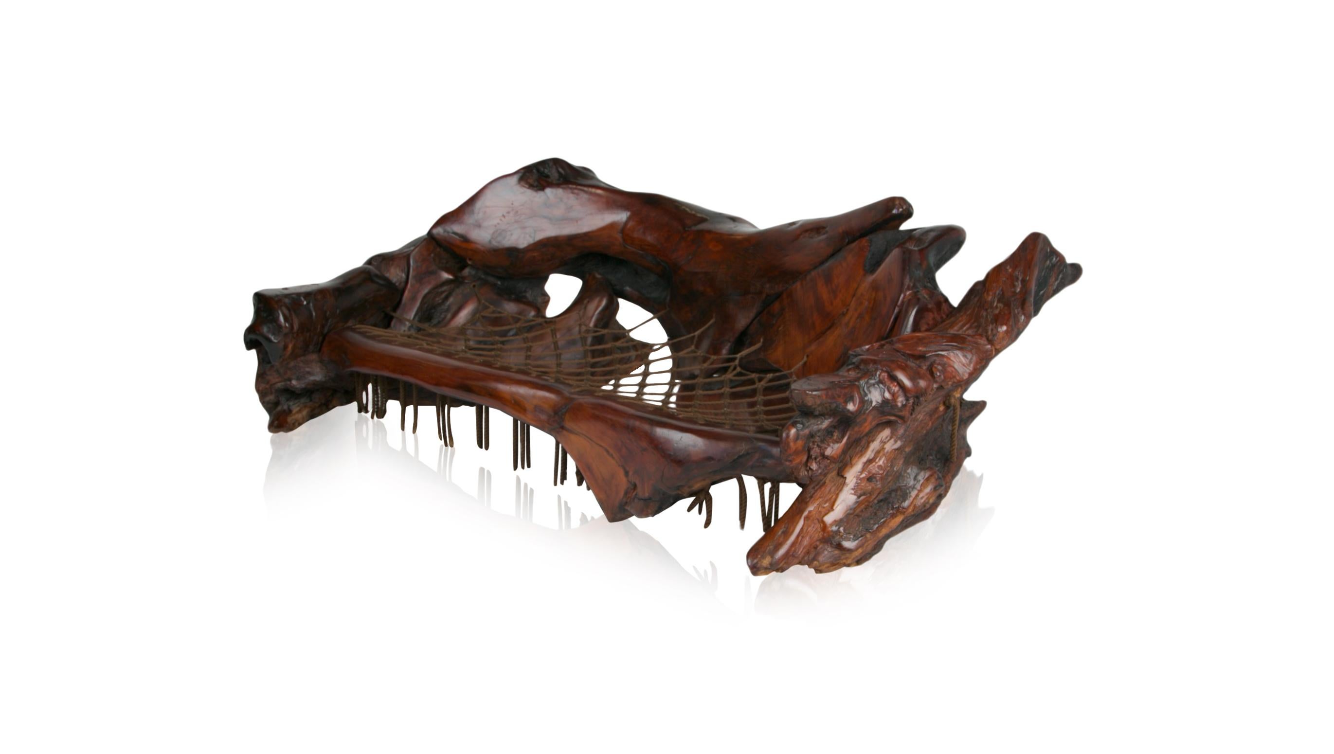 Extraordinary and monumental, this 1970s artisan live edge sculptural root wood sofa was handcrafted from naturally free-formed burl redwood which has been lacquered and worked into an impressive sofa slash craftsman fine art with a Post-Modern