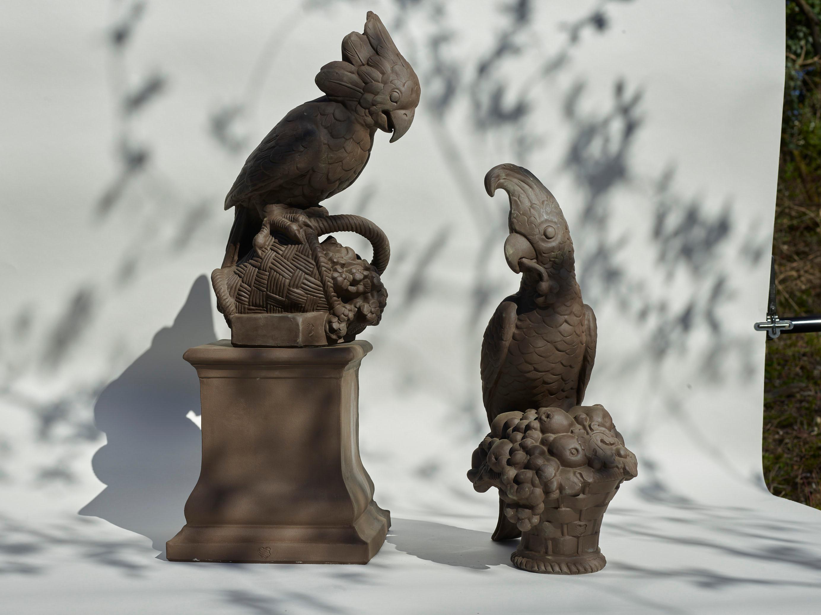 This garden figure of a cockatoo on a pedestal (Our offer is only for this figure and not both birds seen in the mood images) crafted of dark brown manganese clay is a sculptural highlight in every garden. Paired with the respective pedestal, it is