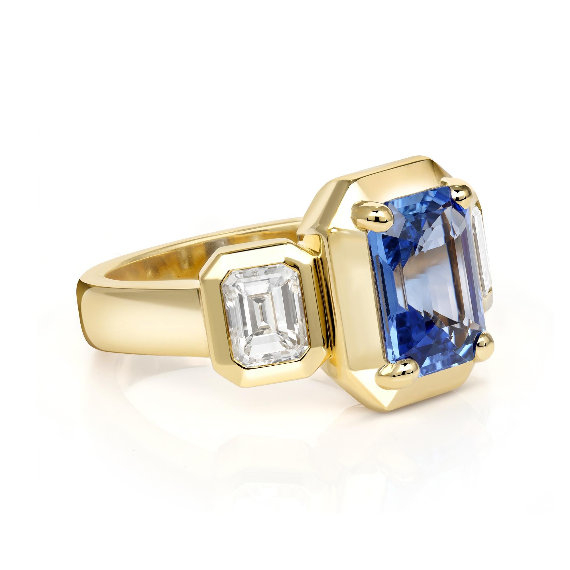 2.90ct Sri Lankan GIA certified emerald cut blue sapphire with 1.00ctw GIA certified emerald cut diamonds prong set in a handcrafted 18K yellow gold mounting.