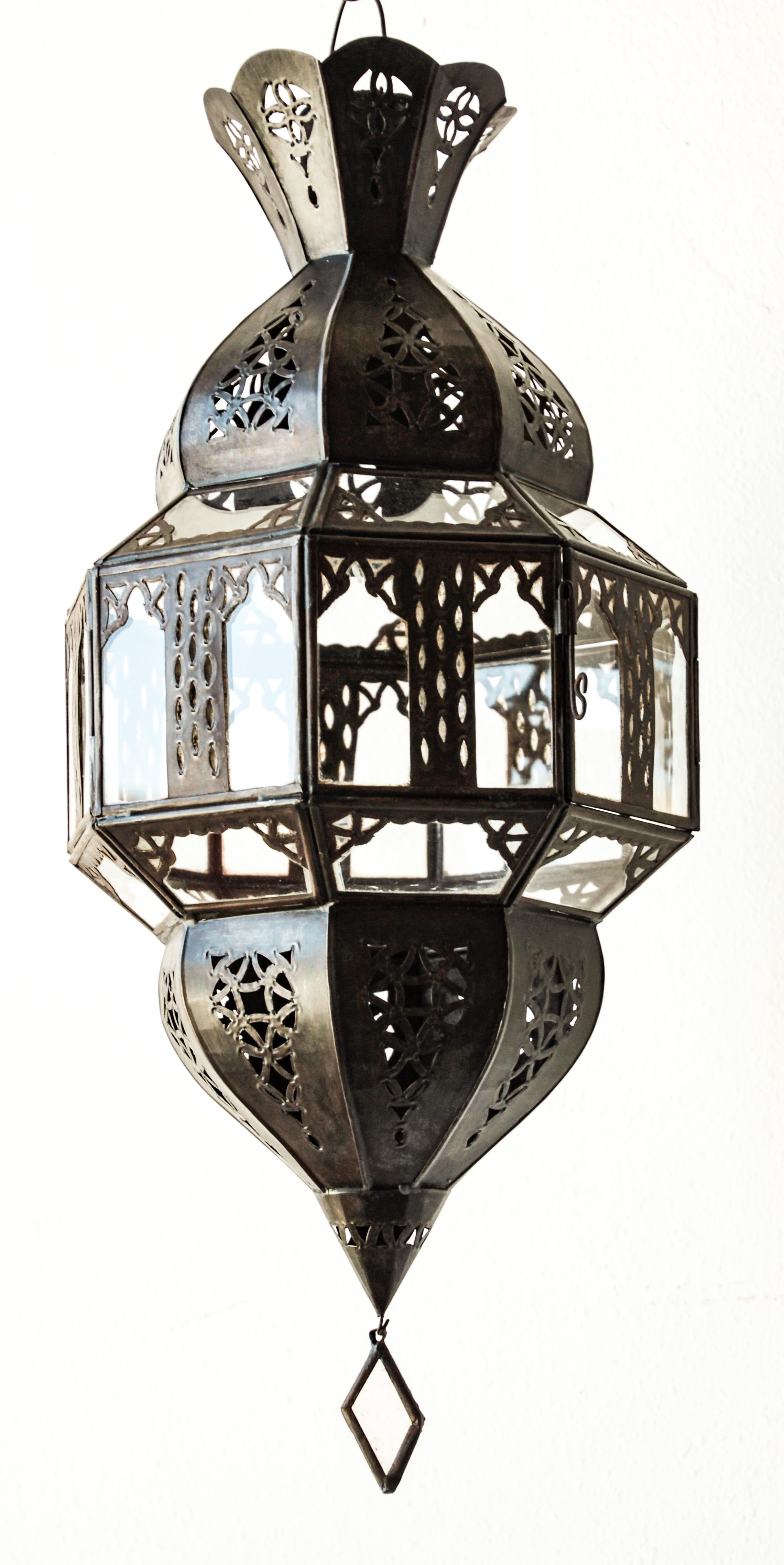 Moroccan bronzed metal and clear glass lantern.
Moroccan Moorish lamp in octagonal shape with rust color metal finish and clear glass.
The top and bottom with Moorish open metal work design.
Moroccan lighting will cast light on the walls with pretty