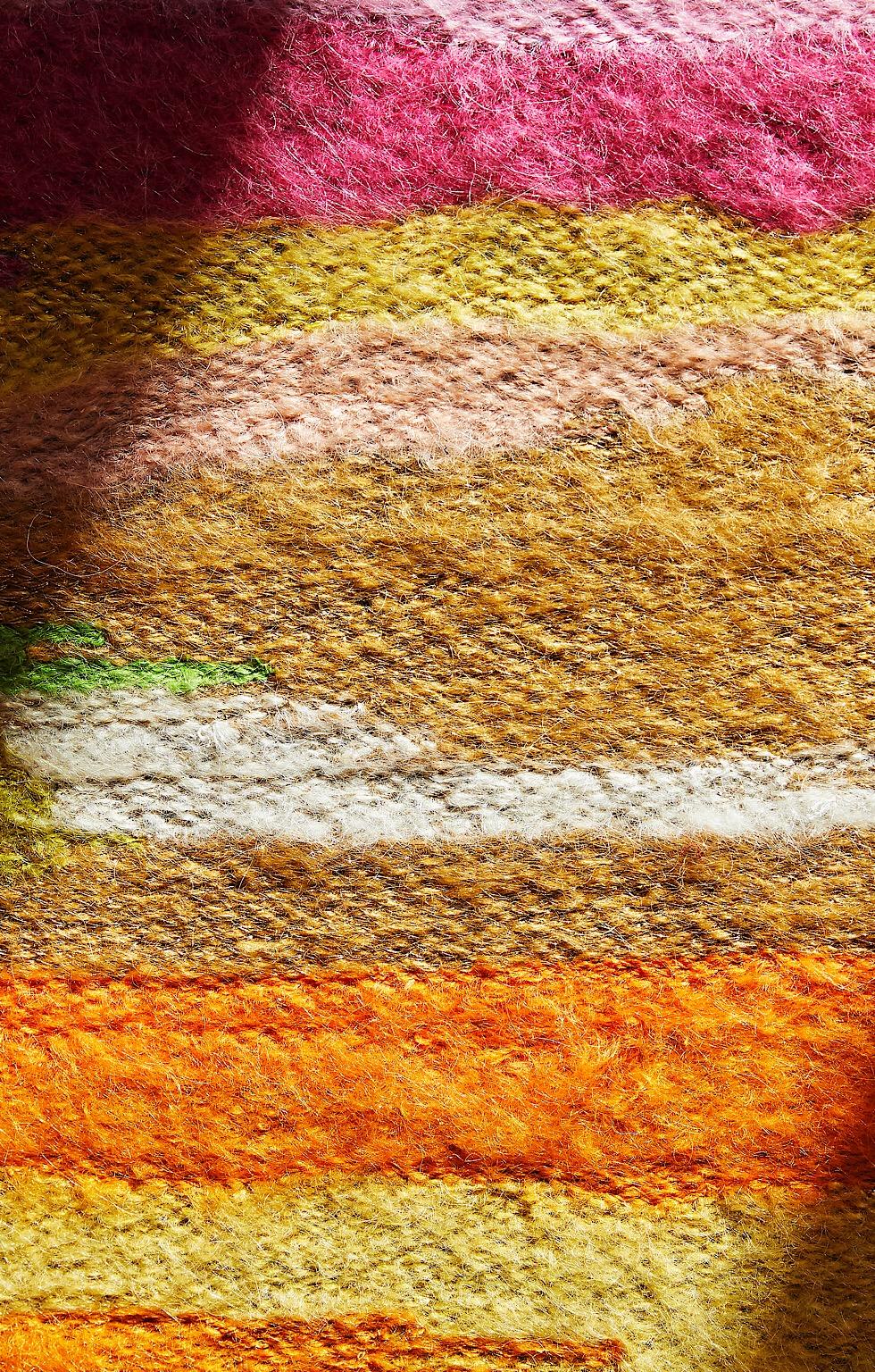 Multicoloured tapestry, hand embroidered mohair and metallic yarn. Uneven stripes of vibrant colour highlighted with a soft gold thread.
