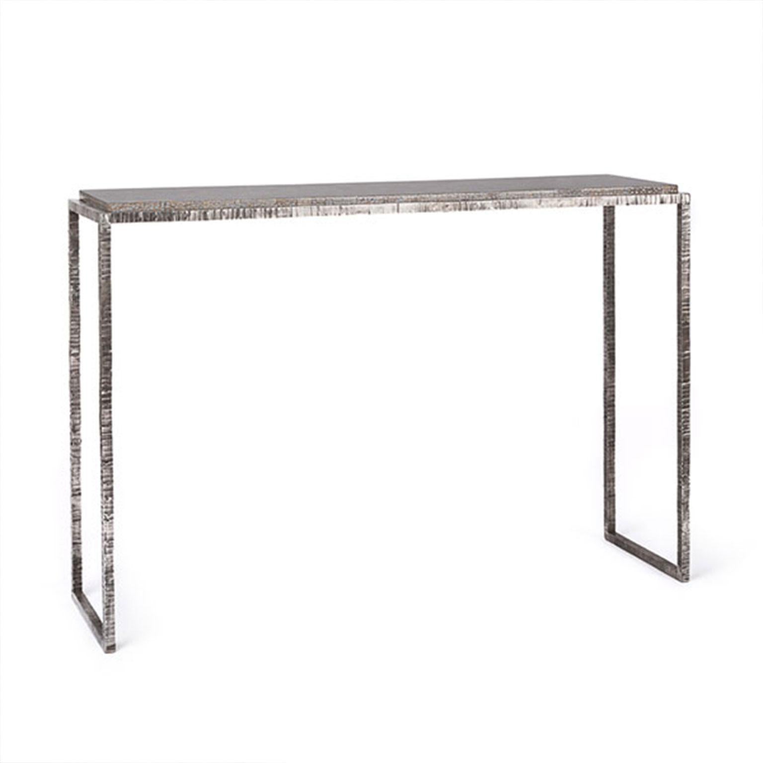 Made from stainless steel, the Hanoi console table has been textured to provide a unique, ripple like texture which has then been polished to create a beautiful shine. Shown here with a specialists egg shell lacquered top.

Designed and