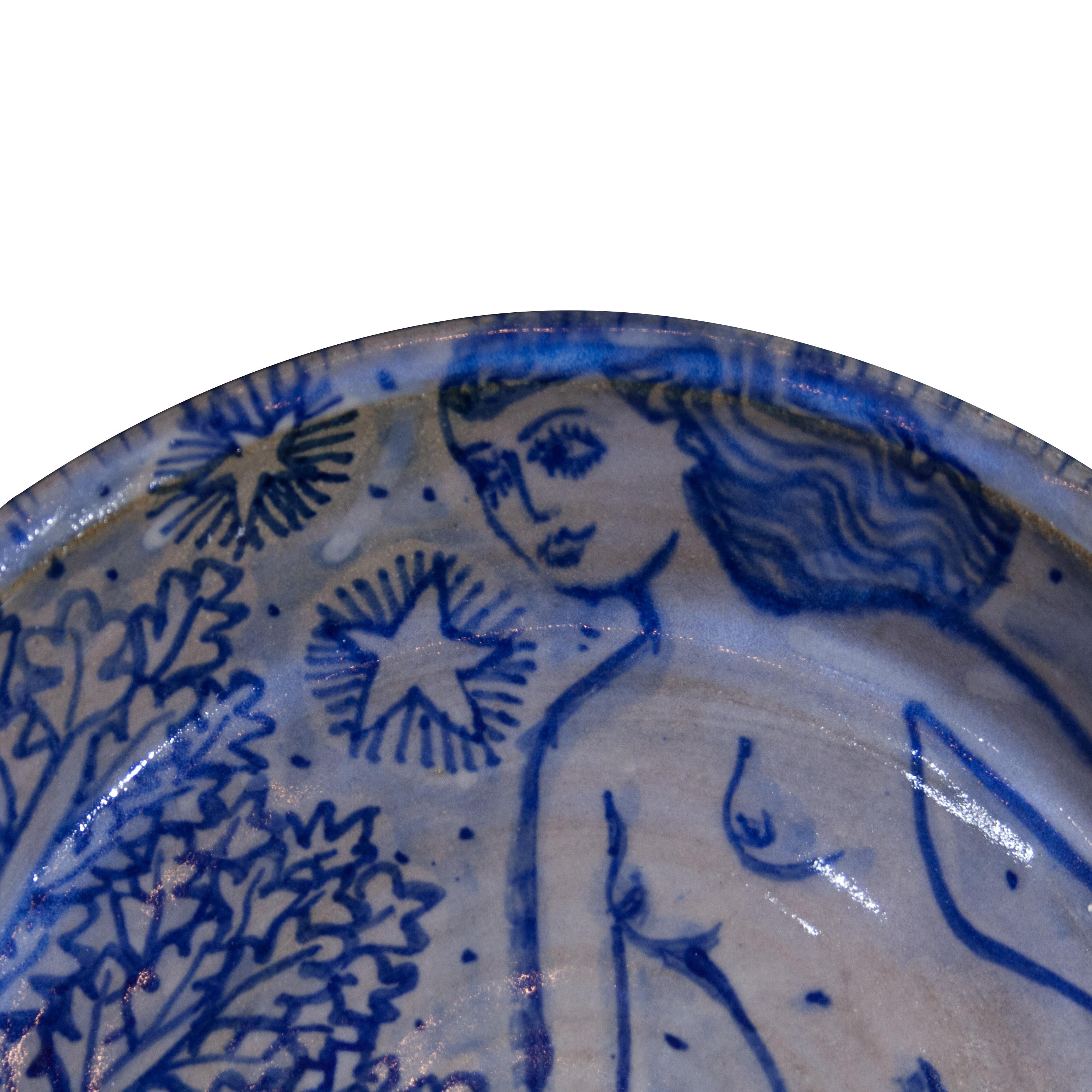 Handcrafted ceramic tall plate by Mathew. Handpainted in blue over light grey background. 