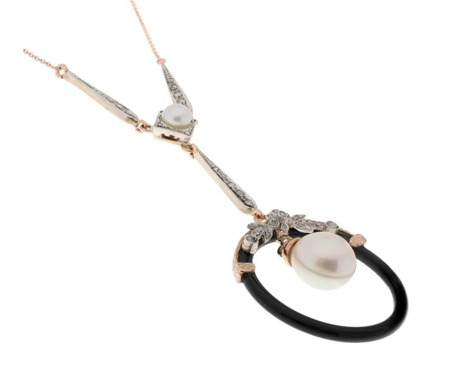 GEMMOLOGIST'S NOTES
This beautifully crafted Art Deco-inspired diamond, pearl and onyx necklace, handcrafted by third generation Italian goldsmiths in Naples, Italy.

Embrace the glamour of the iconic 1920's with this breathtaking piece. Featuring a