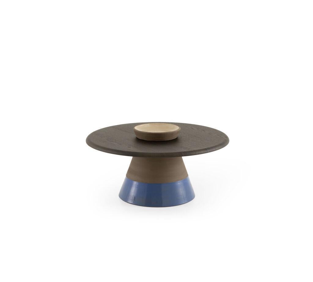 A striking balance of texture and tone, this sculptural side table is a tribute to artisanal mastery. The base is crafted from natural terracotta clay, meticulously shaped by hand on a traditional potter’s wheel and finished with a blend of matte