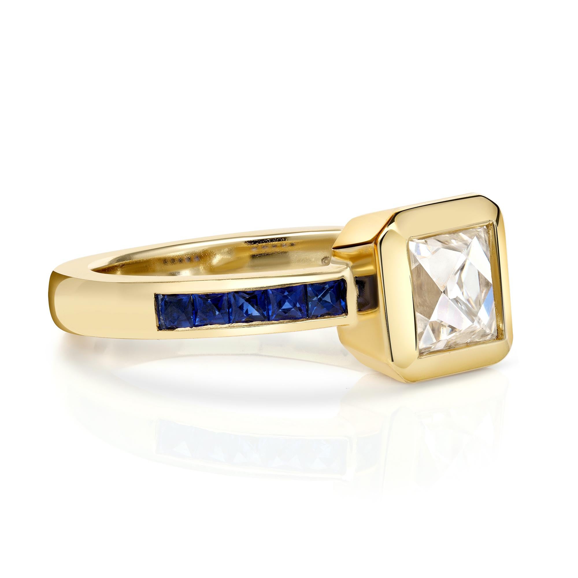 1.15ct K/VS1 GIA certified French cut diamond with 0.39ctw French cut blue sapphire accent stones bezel set in a handcrafted 18K yellow gold mounting.