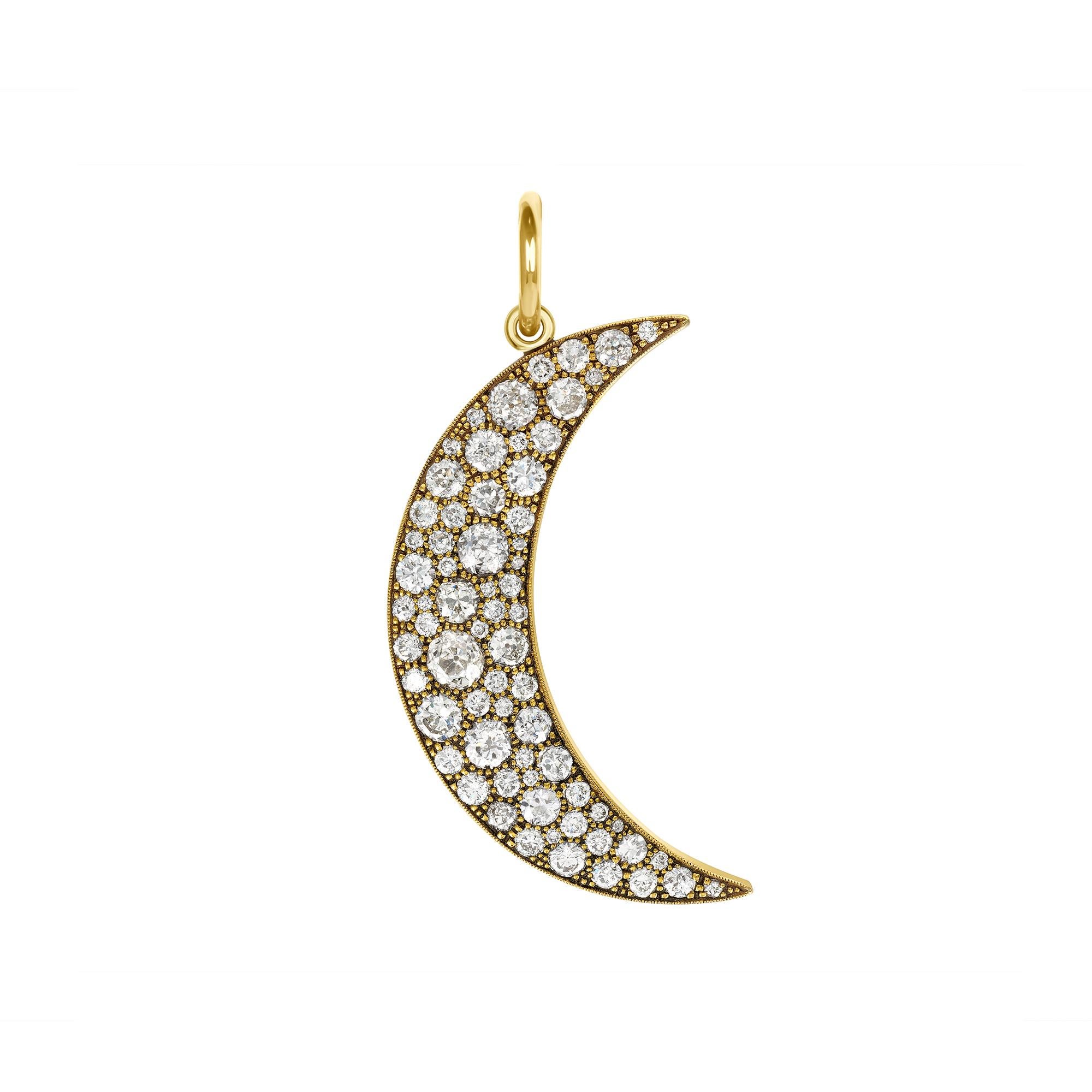 Approximately 4.20ctw varying old cut and round brilliant cut diamonds set in a handcrafted 18K yellow gold crescent moon shaped pendant.