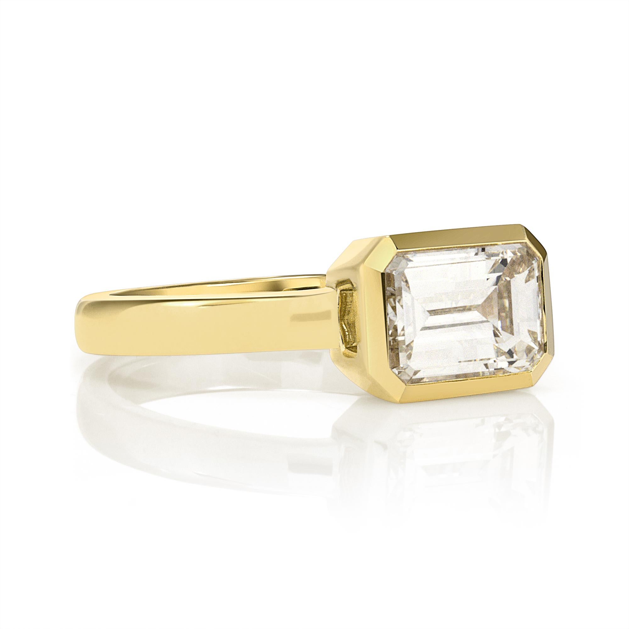 1.50ct M/VS1 GIA certified emerald cut diamond bezel set in a handcrafted 18K yellow gold mounting.