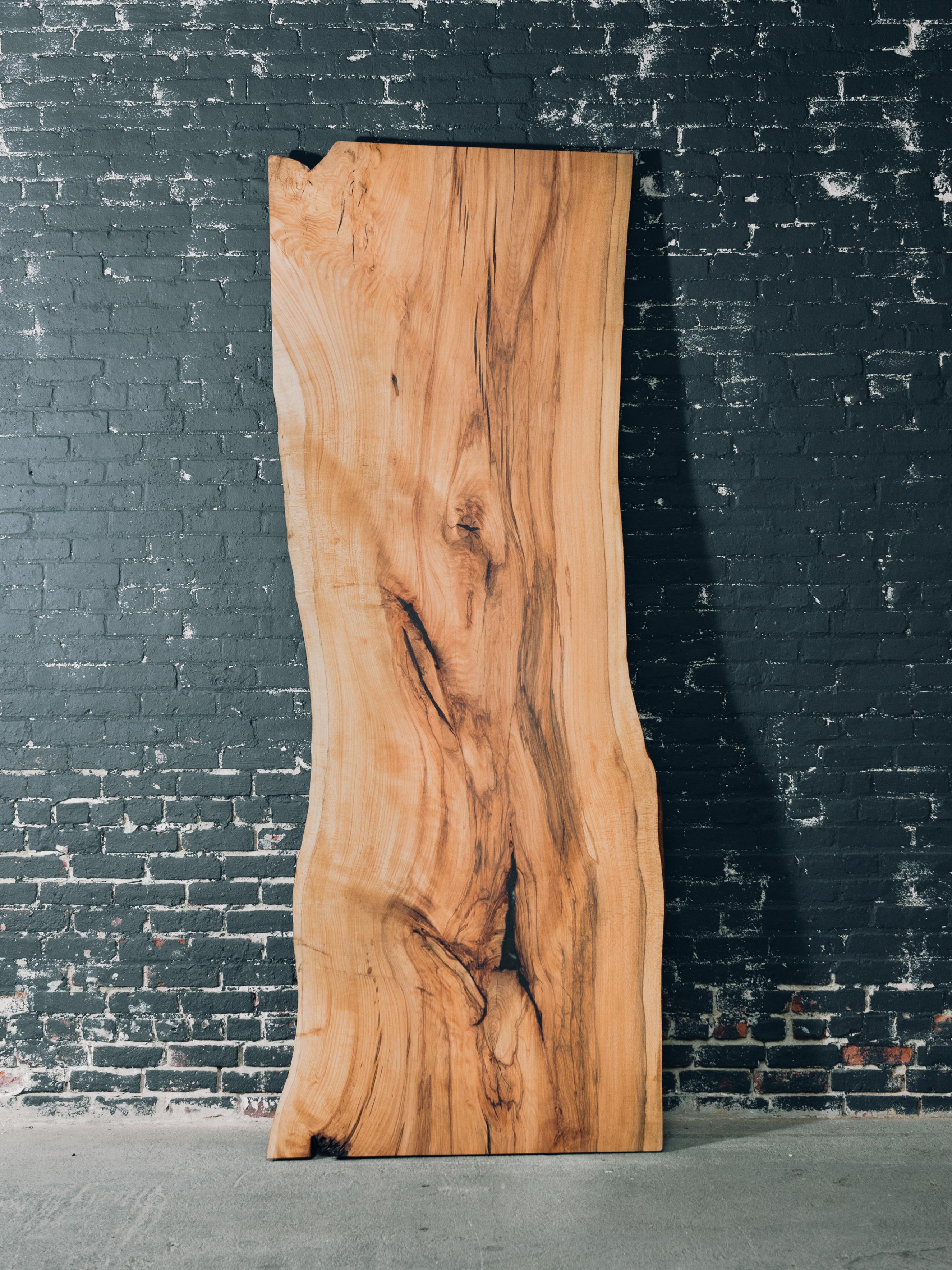 This slab came from a Beech tree that we personally milled on the property of John Adams Museum in Quincy MA. The slab features beautiful wood tones and figure that tell the story of the tree. The voids within the slab have been filled with an epoxy