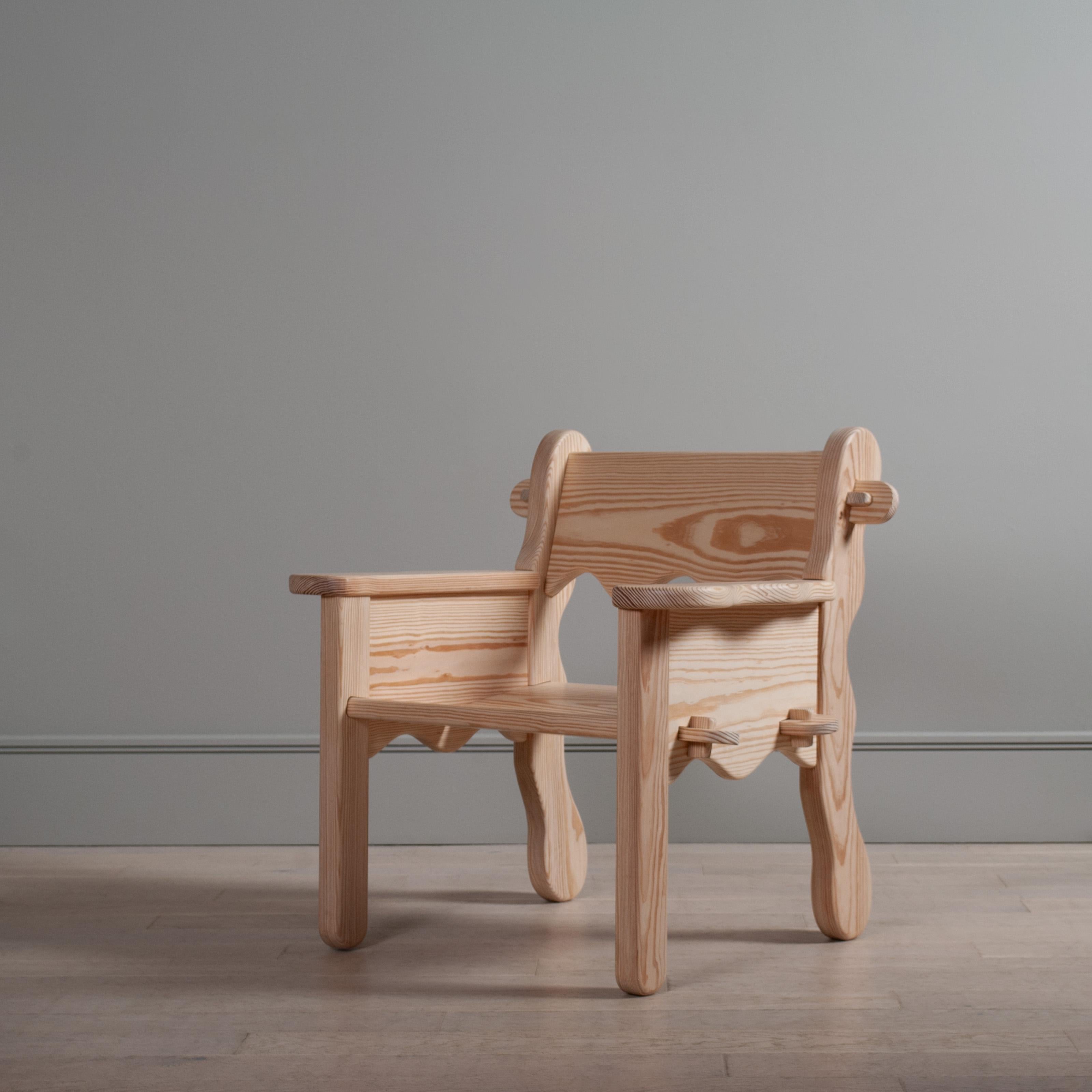 Handcrafted contemporary lounge chair in yellow pine. The freehand waves cut into the wood in this arm chair beautifully enhance the gorgeous growth ring patterns in this timber. 

The wide arms provide a convenient place to rest a drink or book.
