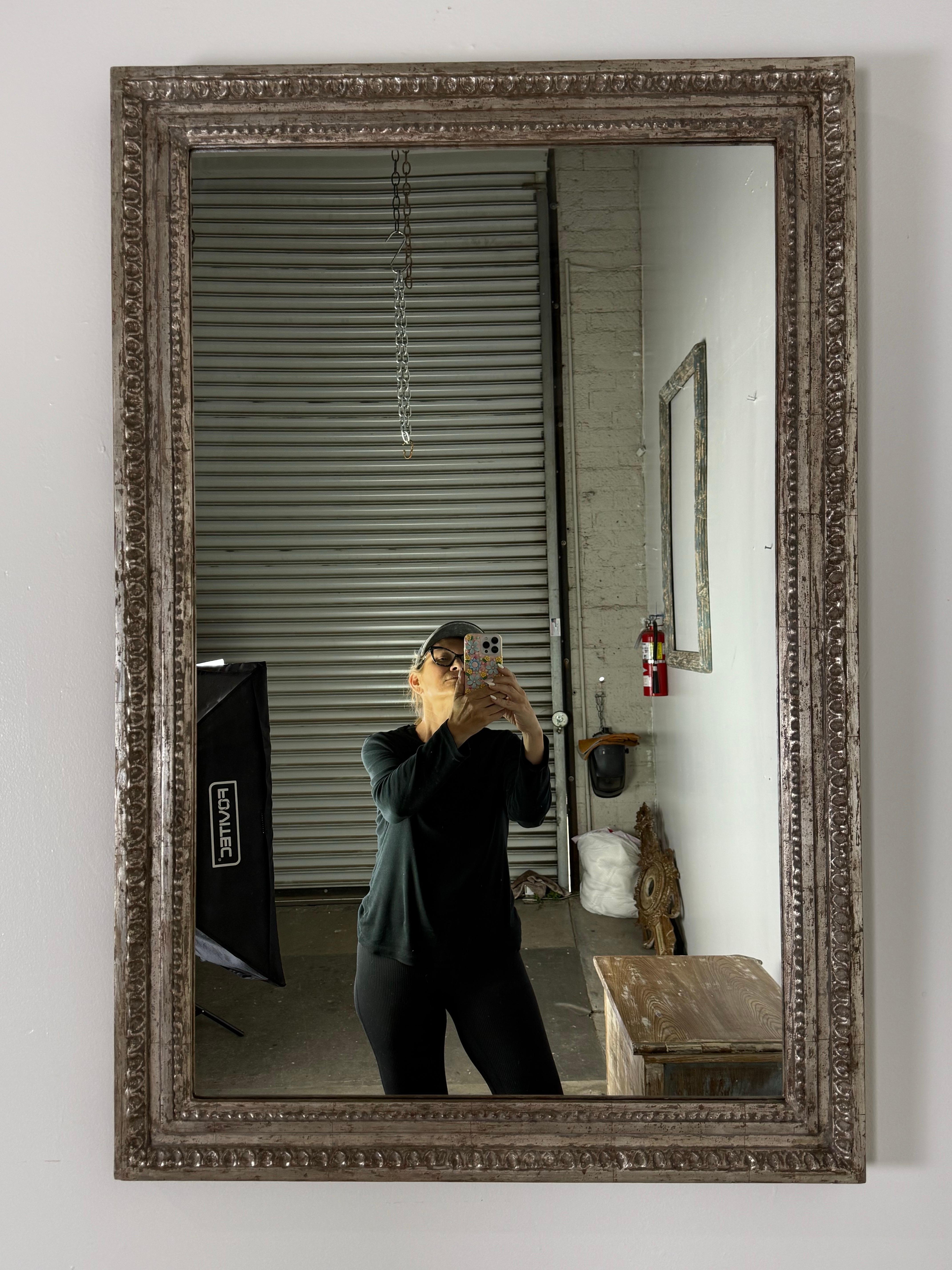 This beautifully handcrafted mirror, designed by Melissa Levinson for Miamar Home, features an elegant, classically inspired frame with intricate detailing throughout. The solid wood frame is hand-carved in Los Angeles by skilled artisans and