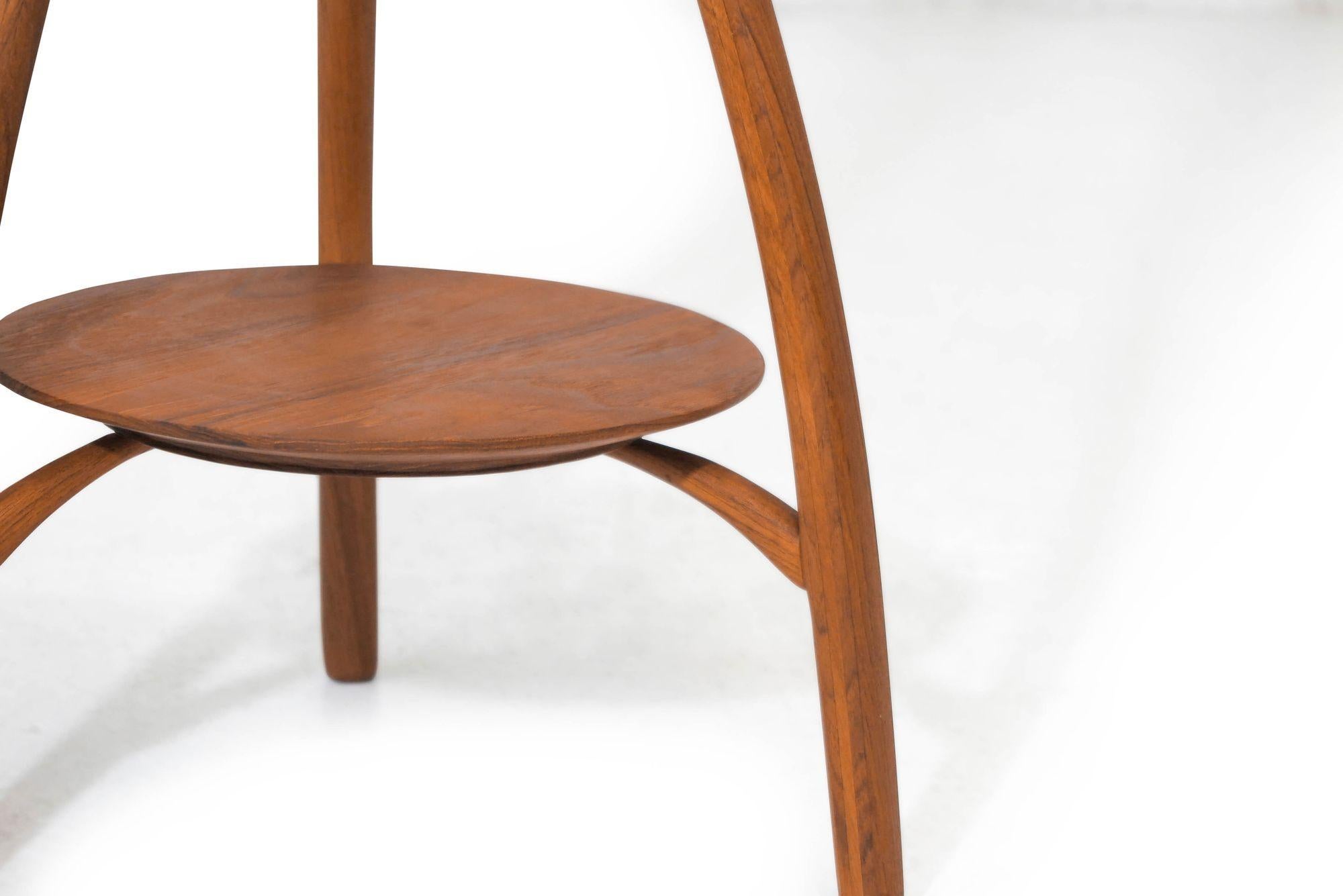 Mid-century side table handcrafted of solid teak in a sculptural form.
Measurements 
W 16.25 x D 16.25'' x H 34.75'' 
Lower and upper disc diameter 12.66''.