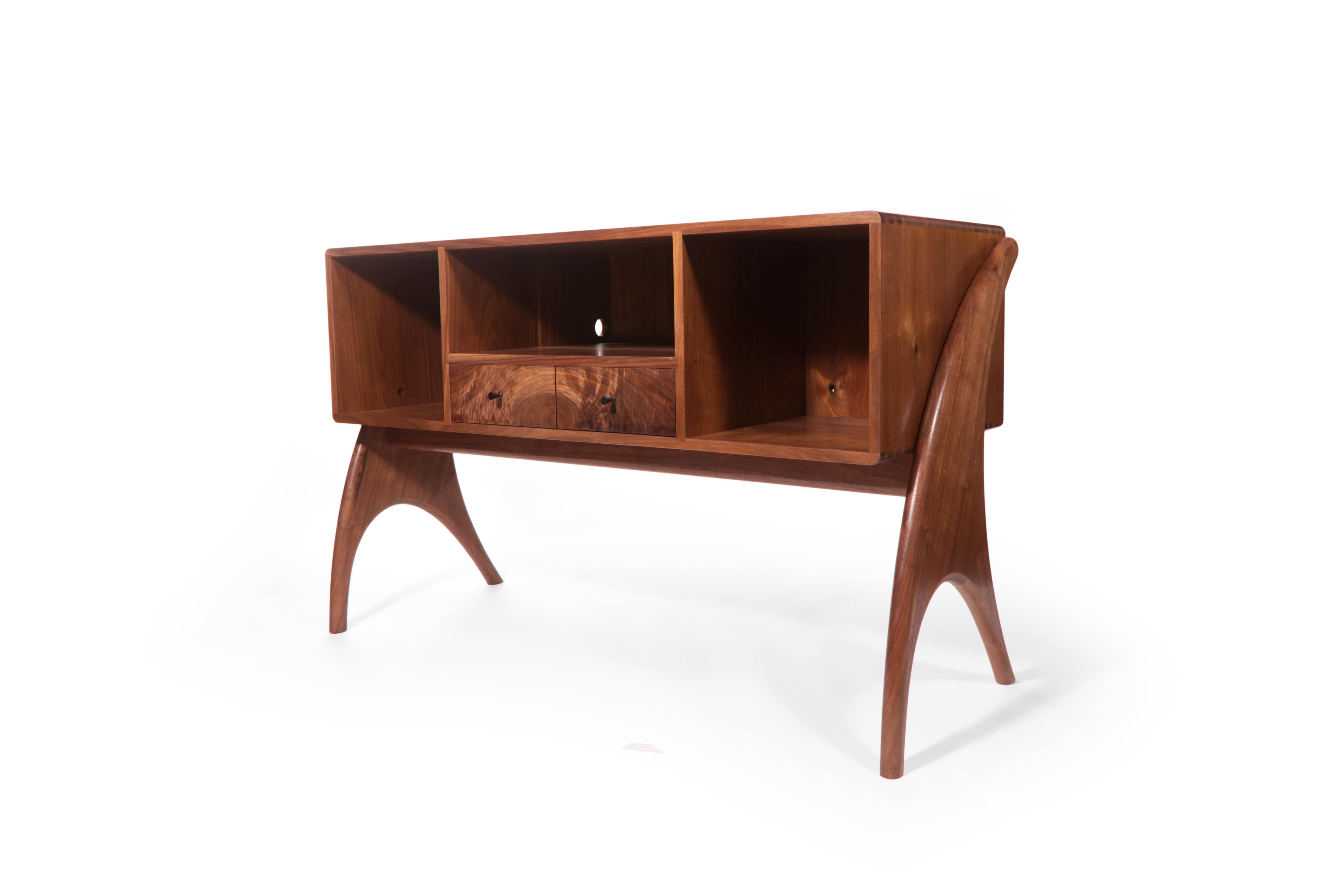 House your music collection in something beautiful! Handcrafted from solid black walnut, my midcentury record cabinet is designed to house your equipment and records in one place. With long curving legs and incredible hand-cut dovetail joinery, this