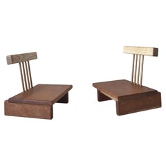 Handcrafted mixed wood low chairs with cantilevered spindle back and tiered base