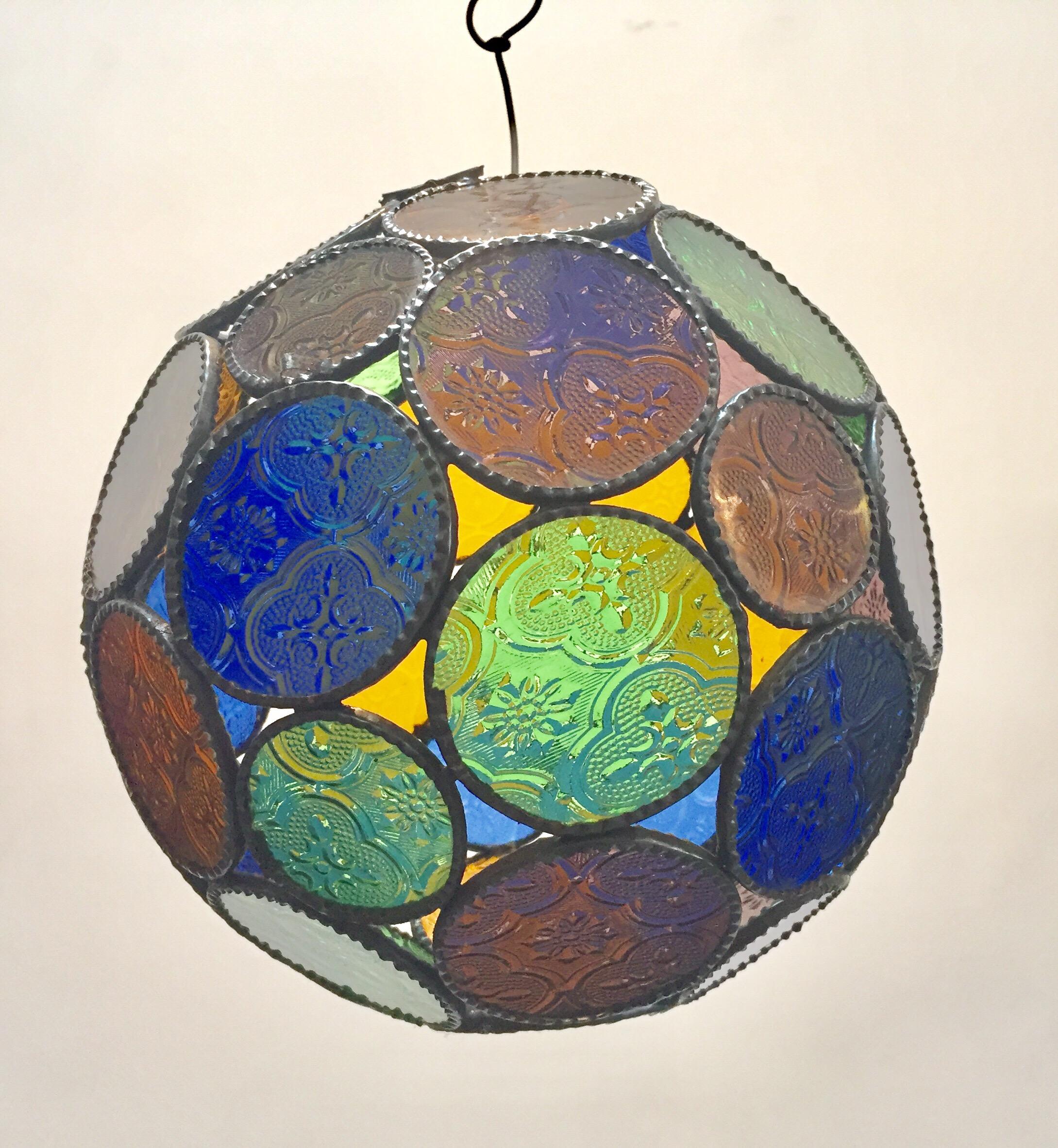 Handcrafted Moroccan multi-color glass lantern or Moorish pendant. Multi-color molded glass colors in blue, green, lavender and amber. with Moorish design circles put together in an orb style lamp. Handmade in Marrakech, metal rust color finish,