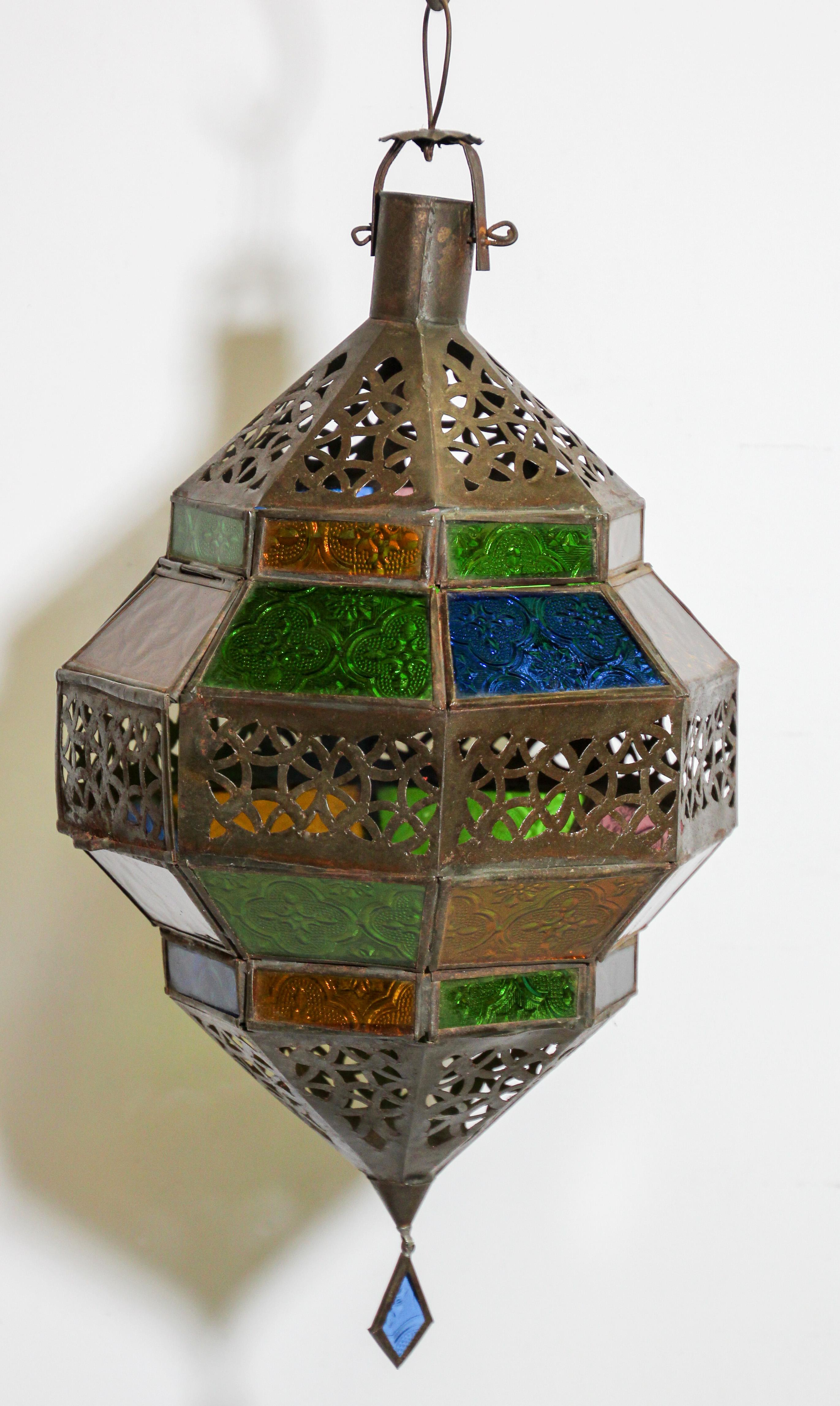 Moroccan metal and multi-color glass lantern, amber, green, lavender, blue glass lantern in diamond shape.
Moroccan lantern in octagonal shape with rust color metal finish and blue glass.
The top and bottom with open metal work Moorish design.
This