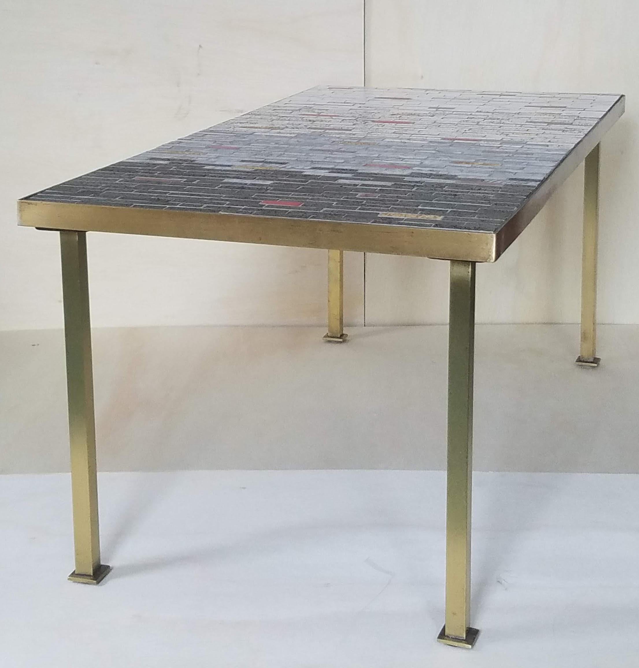 An early 1950's custom designed coffee table created at the Clay Mosaics & Ceramics, Inc. studio which was located at 432 East 82nd Street in New York.
The gradual change of the color from white to charcoal grey is an interesting design.
The