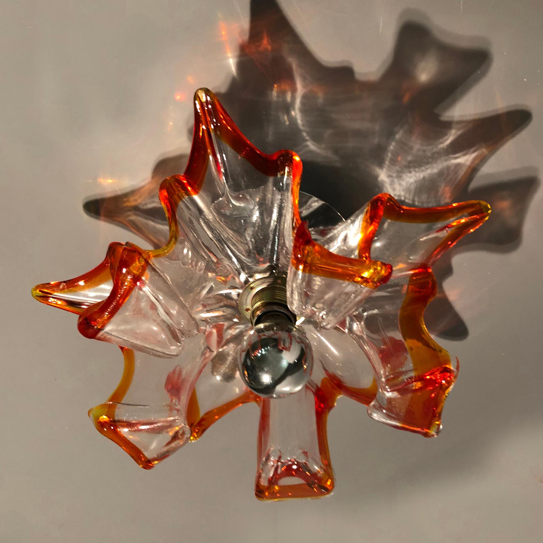 Vintage Italian wall lights or flushmount with hand blown clear Murano glasses with amber edge and mounted on metal base.
Shown with designer light bulb with silver tip detail, not included. E14 socket.
May be used as wall sconces or mounted to