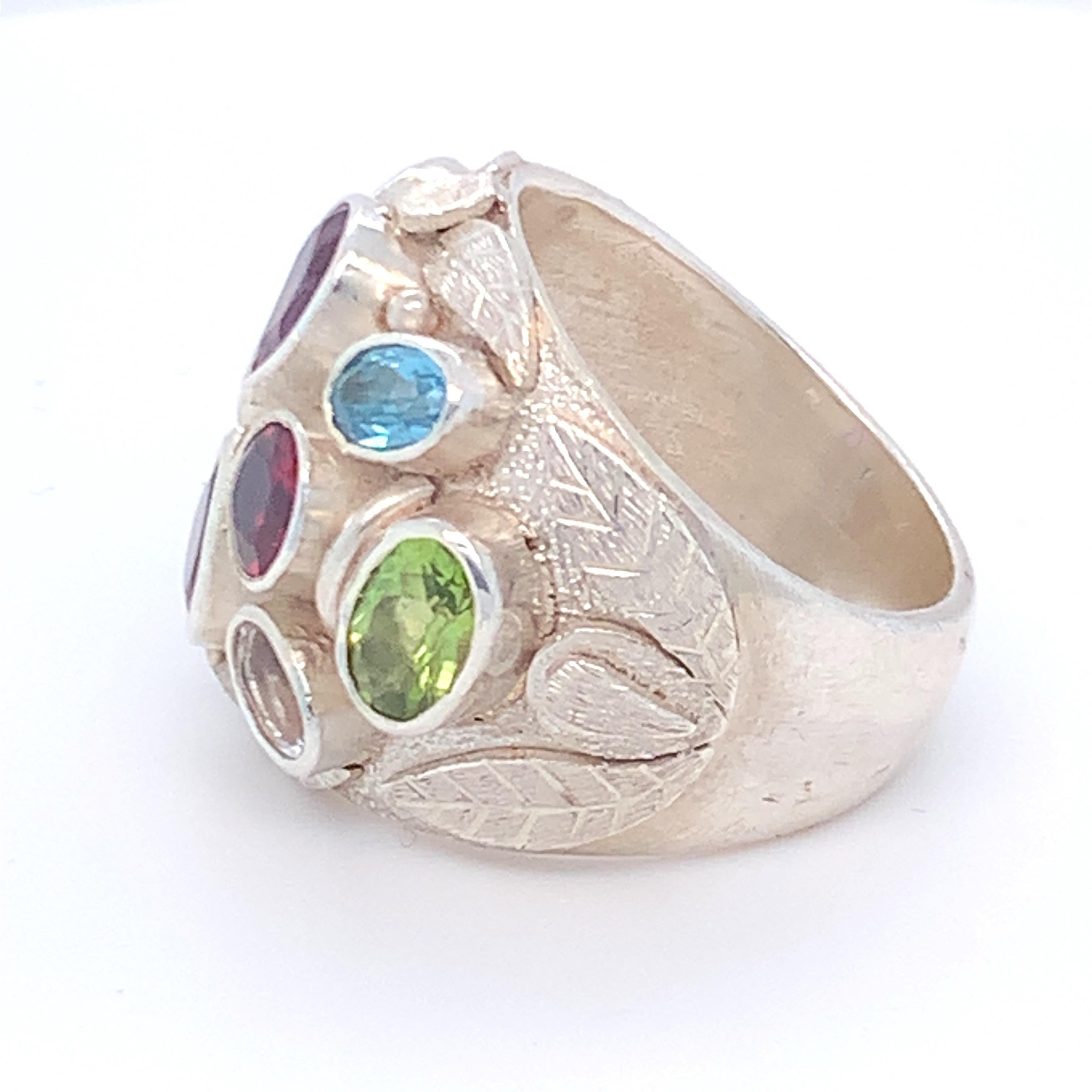 This multi gem cocktail ring is set in sterling silver. Carefully selected amethyst, peridot, blue topaz, crystal and garnet are used on this  handcrafted stunning piece of jewelry.
Approximate Size:
Multi gem: 7.00ct