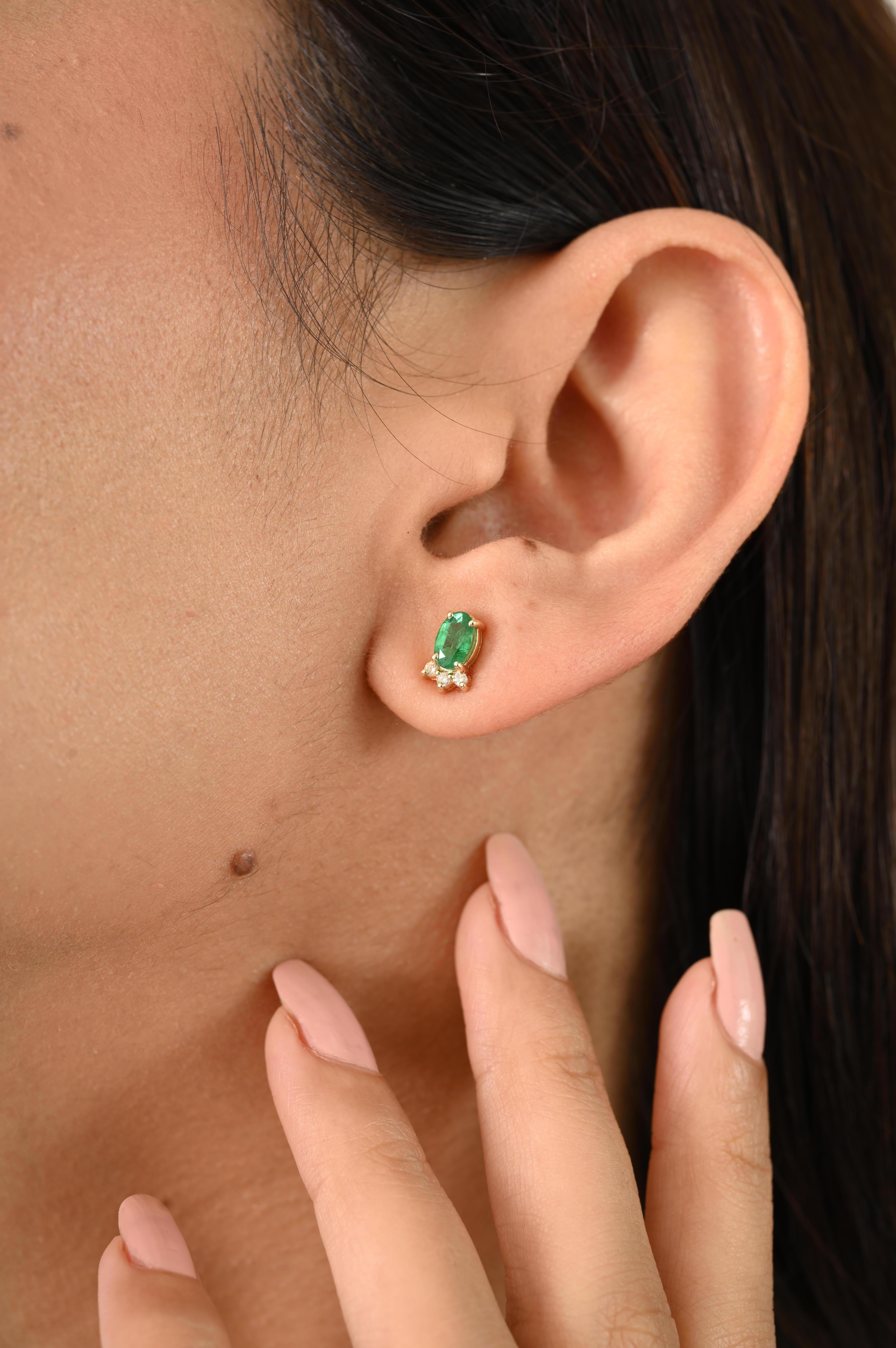 Handcrafted stud earrings featuring natural Zambian emeralds 0.88 and sparkling diamonds 0.07 set in a secure prong setting in 14k yellow gold, offering a timeless and elegant look.
Emerald enhances intellectual capacity of the person. 
Designed