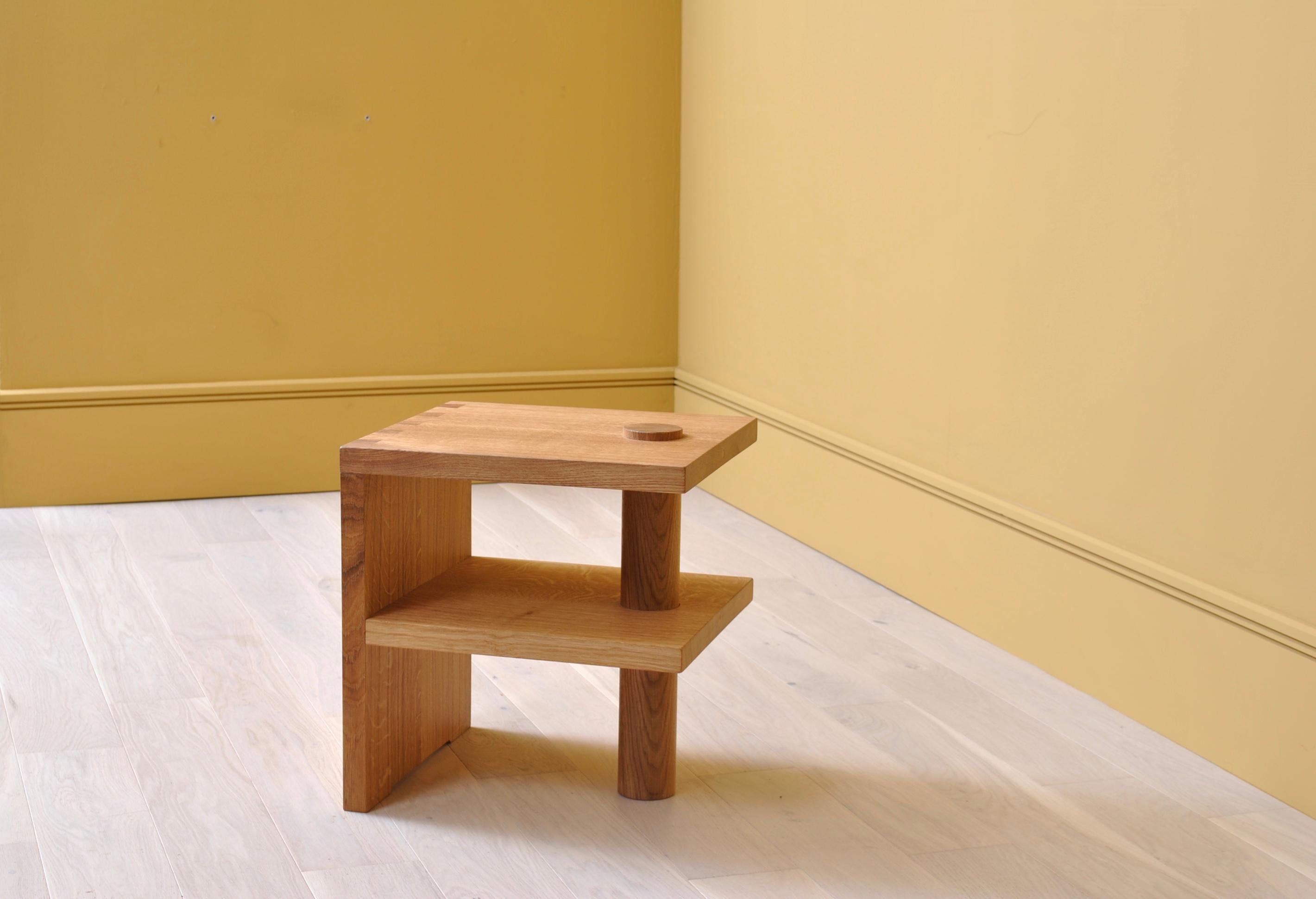 Architectural Postmodern oak pillar end or side table. Designed by SUM furniture and handcrafted using traditional techniques from fully quartersawn English oak. Handcut dovetail jointing with turned oak upright pillar piercing through the sections.